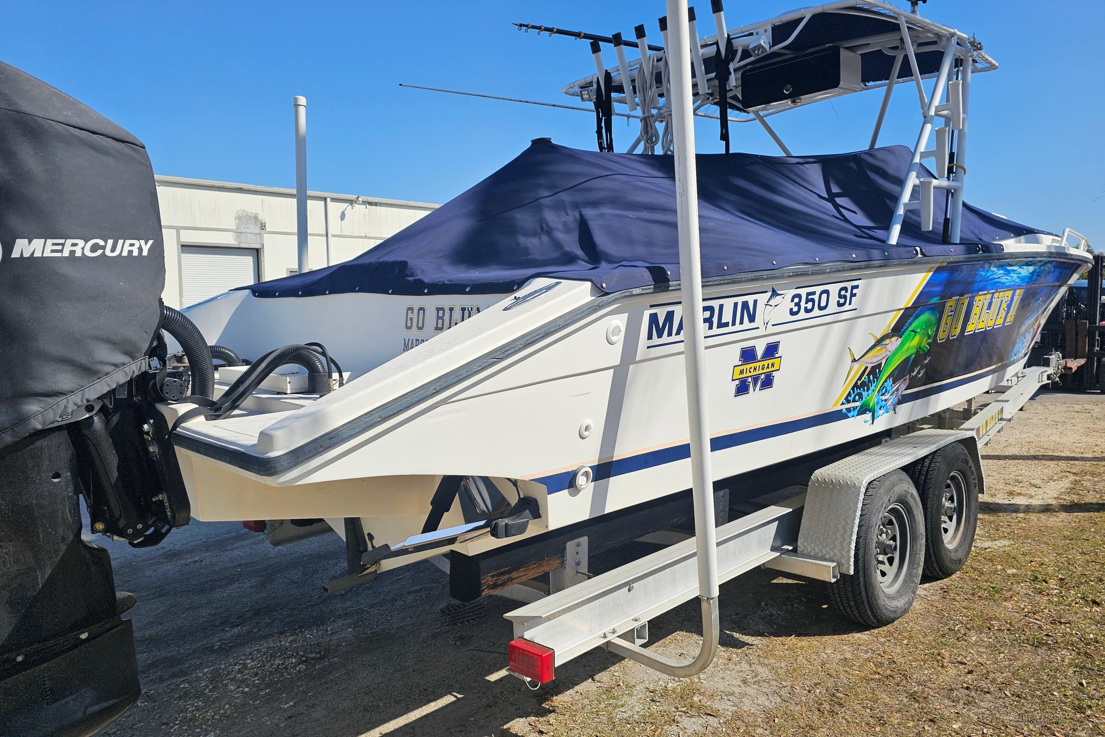 1993 Marlin 350 Sportfish boat on trailer, covered, with Mercury engine.