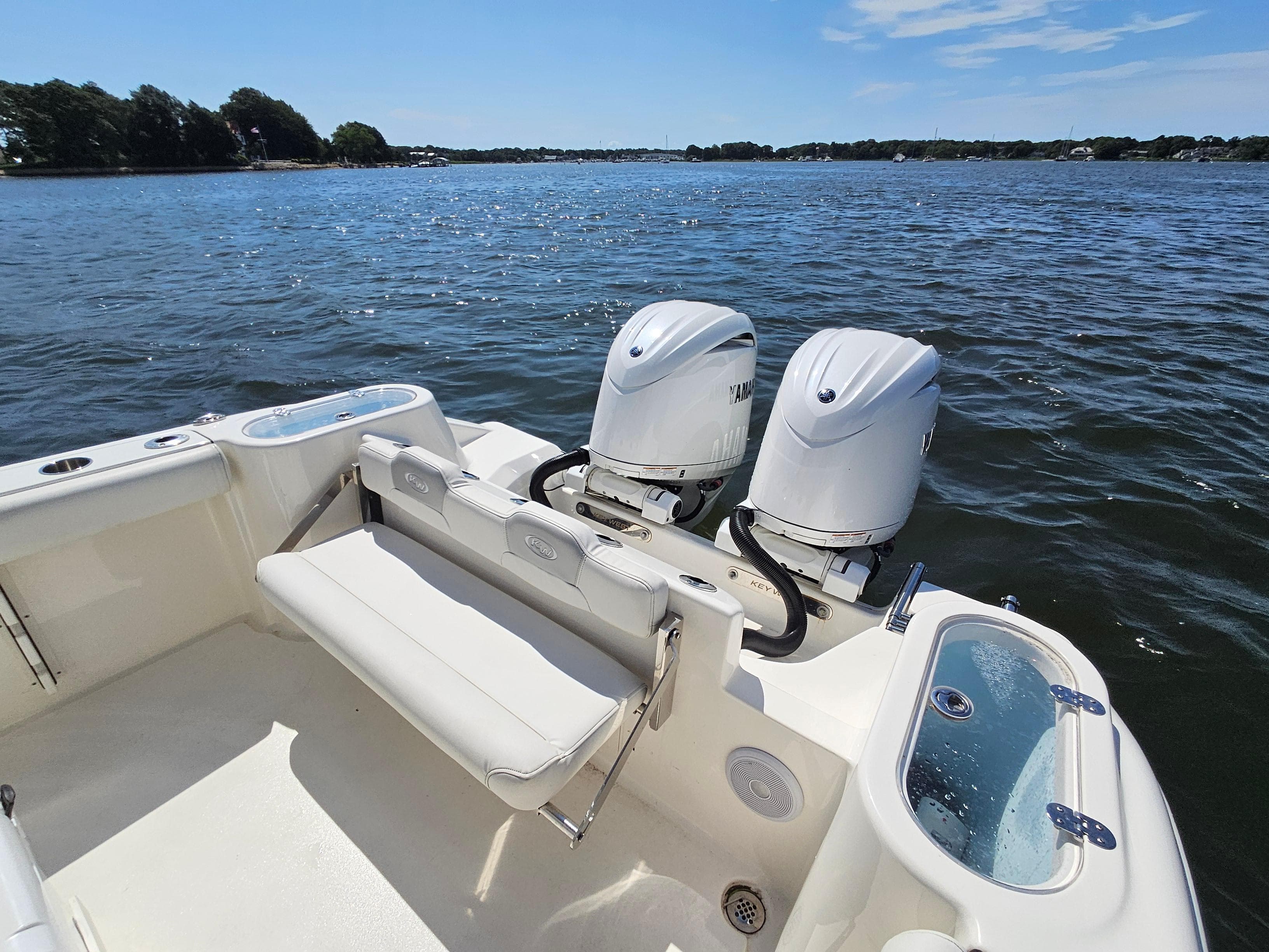 2024 Key West 244 Center Console boat with twin engines on a sunny day.