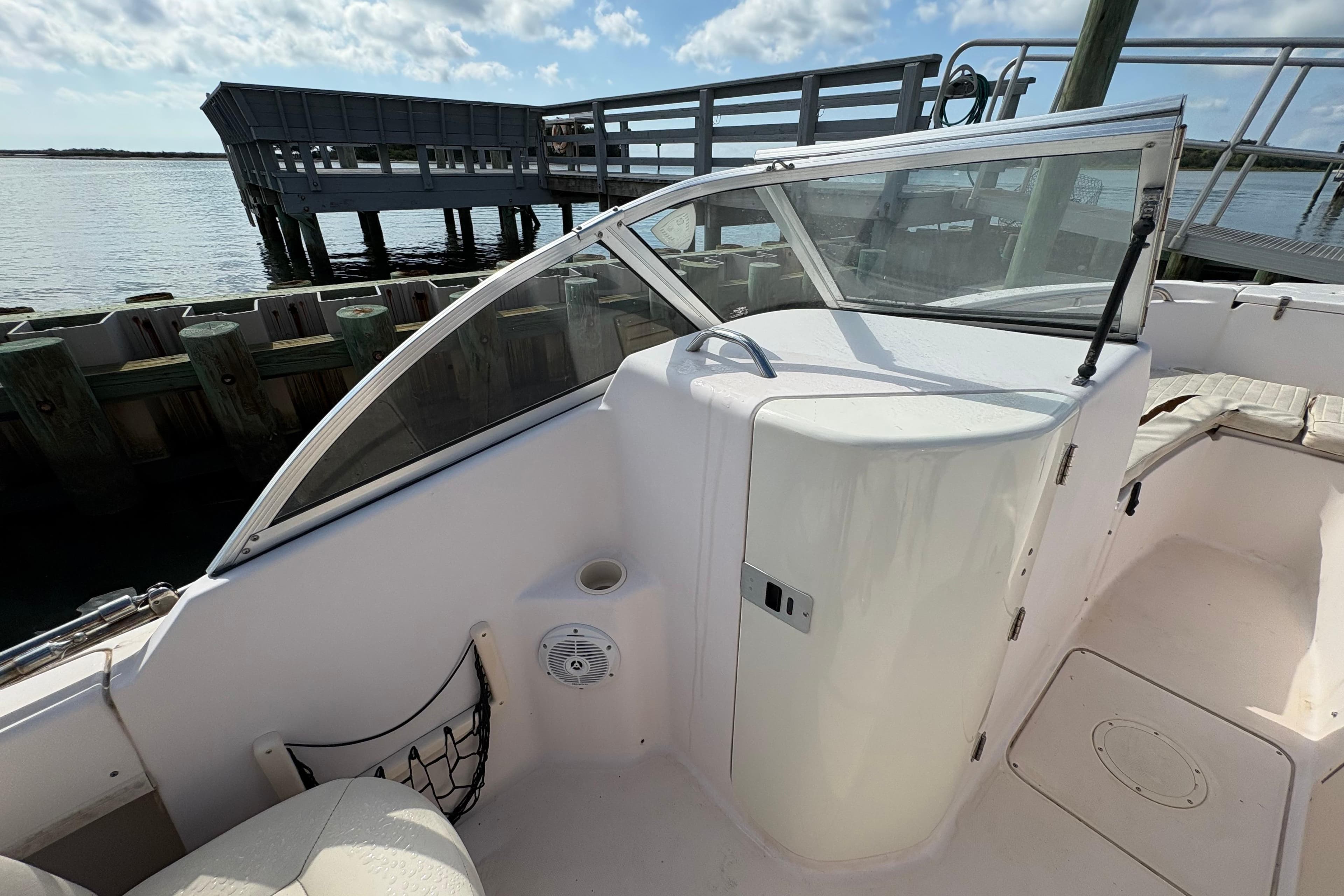 2008 Grady-White Tournament 205 boat interior with seating and storage, docked by the water.