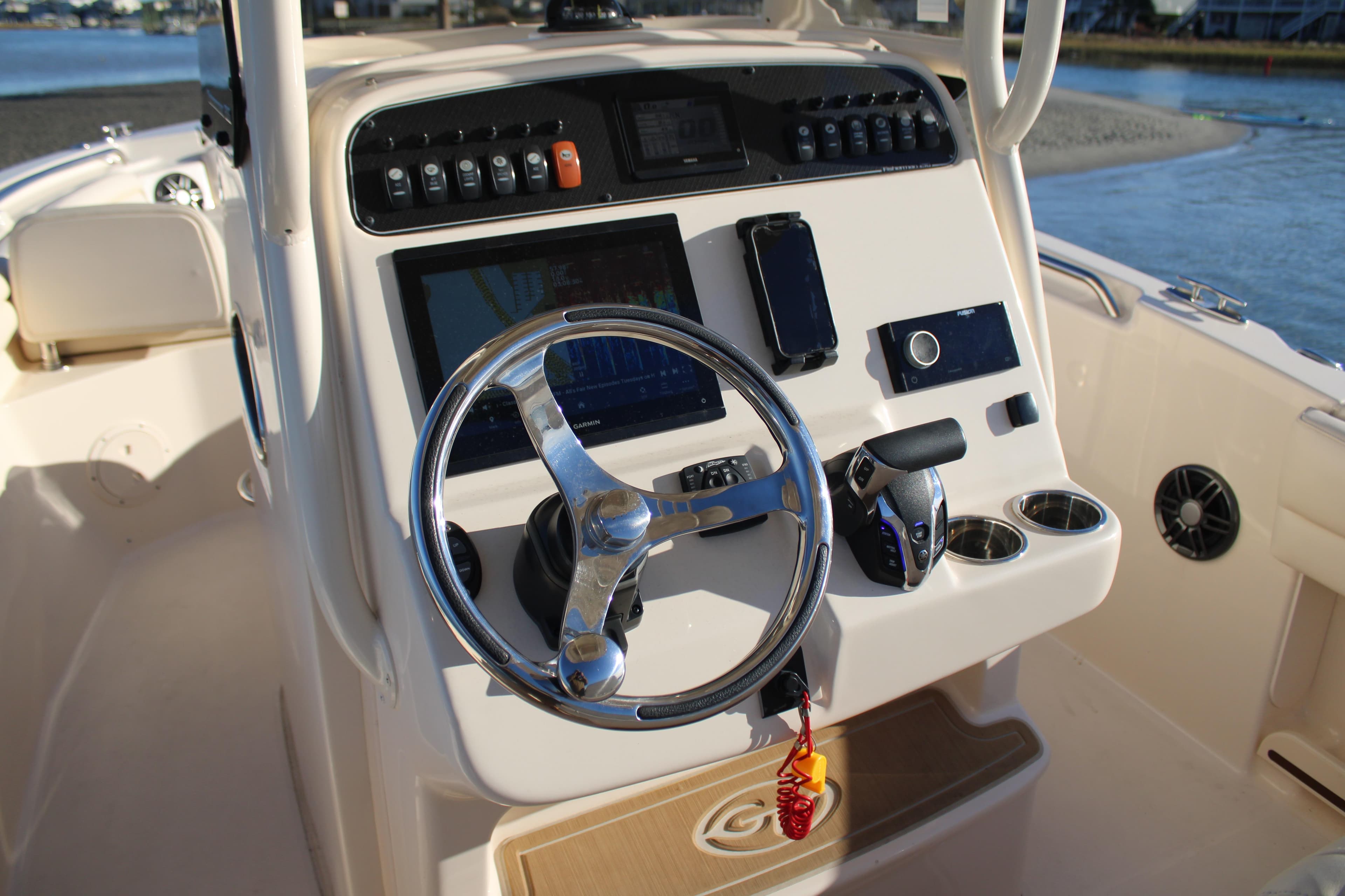 2024 Grady-White Fisherman 216 boat console with steering wheel and navigation controls.