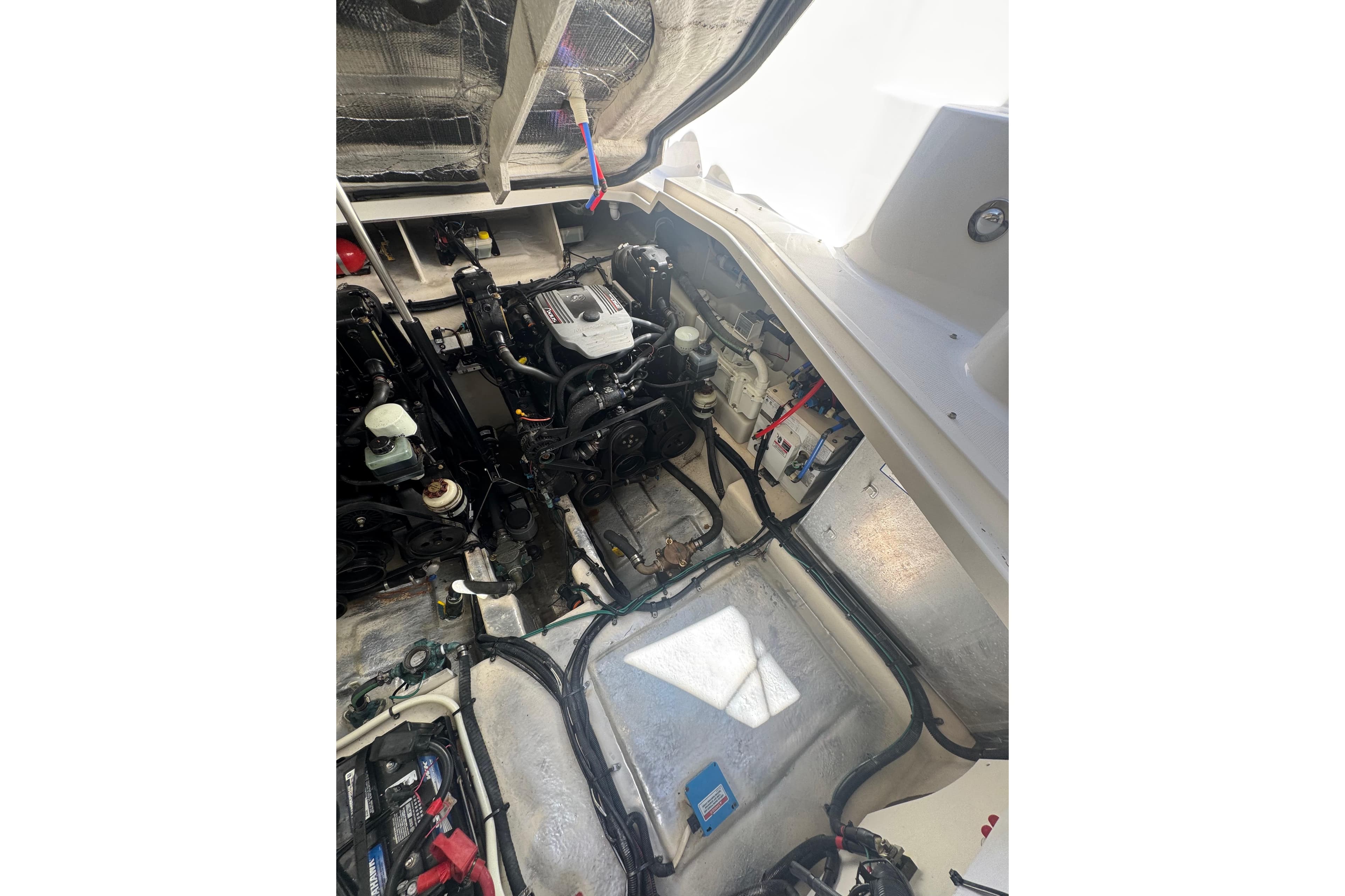 Engine compartment of 2010 Searay 330 Sundancer boat, showcasing mechanical components and wiring.