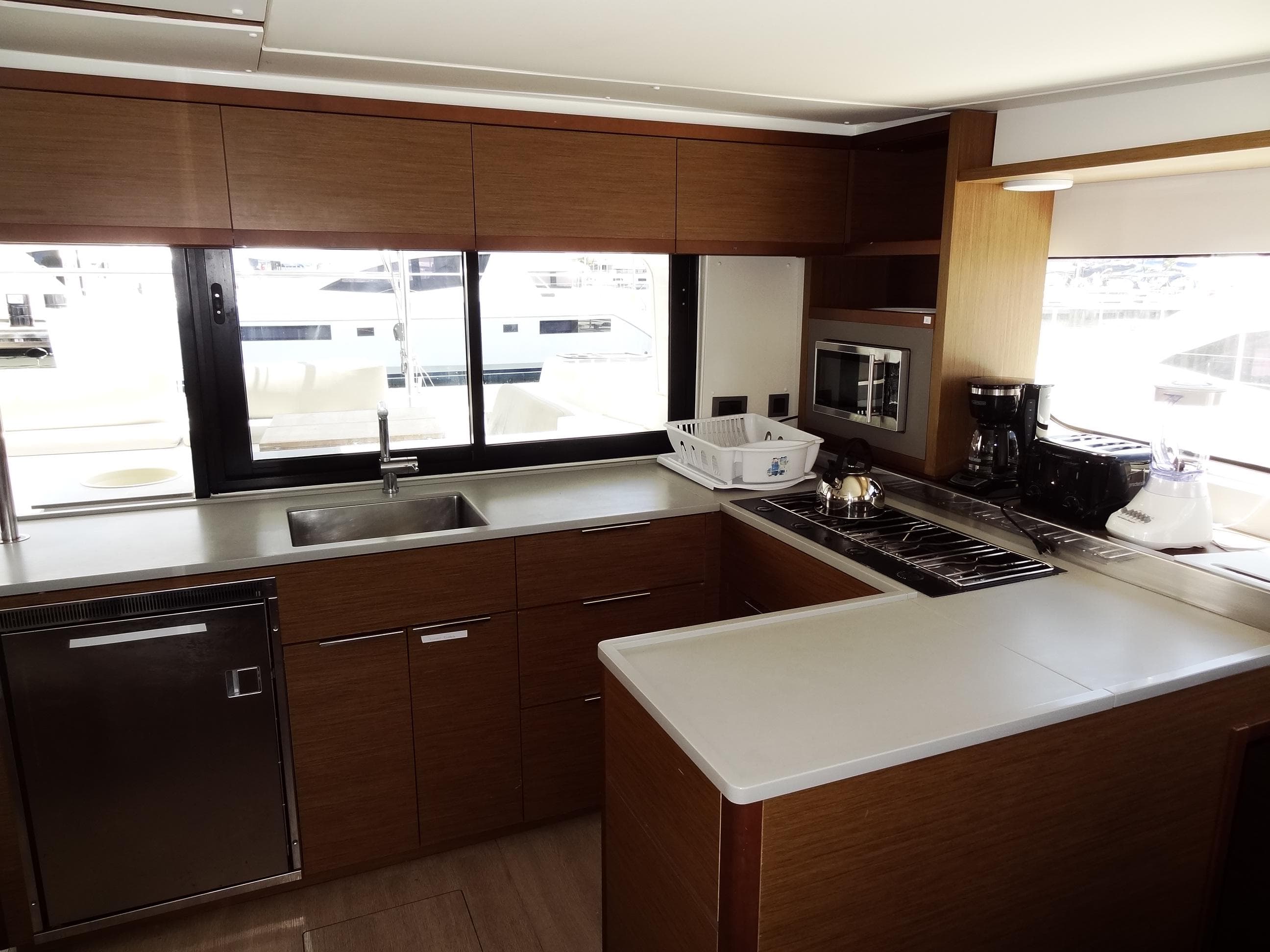 Modern kitchen interior of 2020 Lagoon 46 yacht with sleek cabinetry and appliances.
