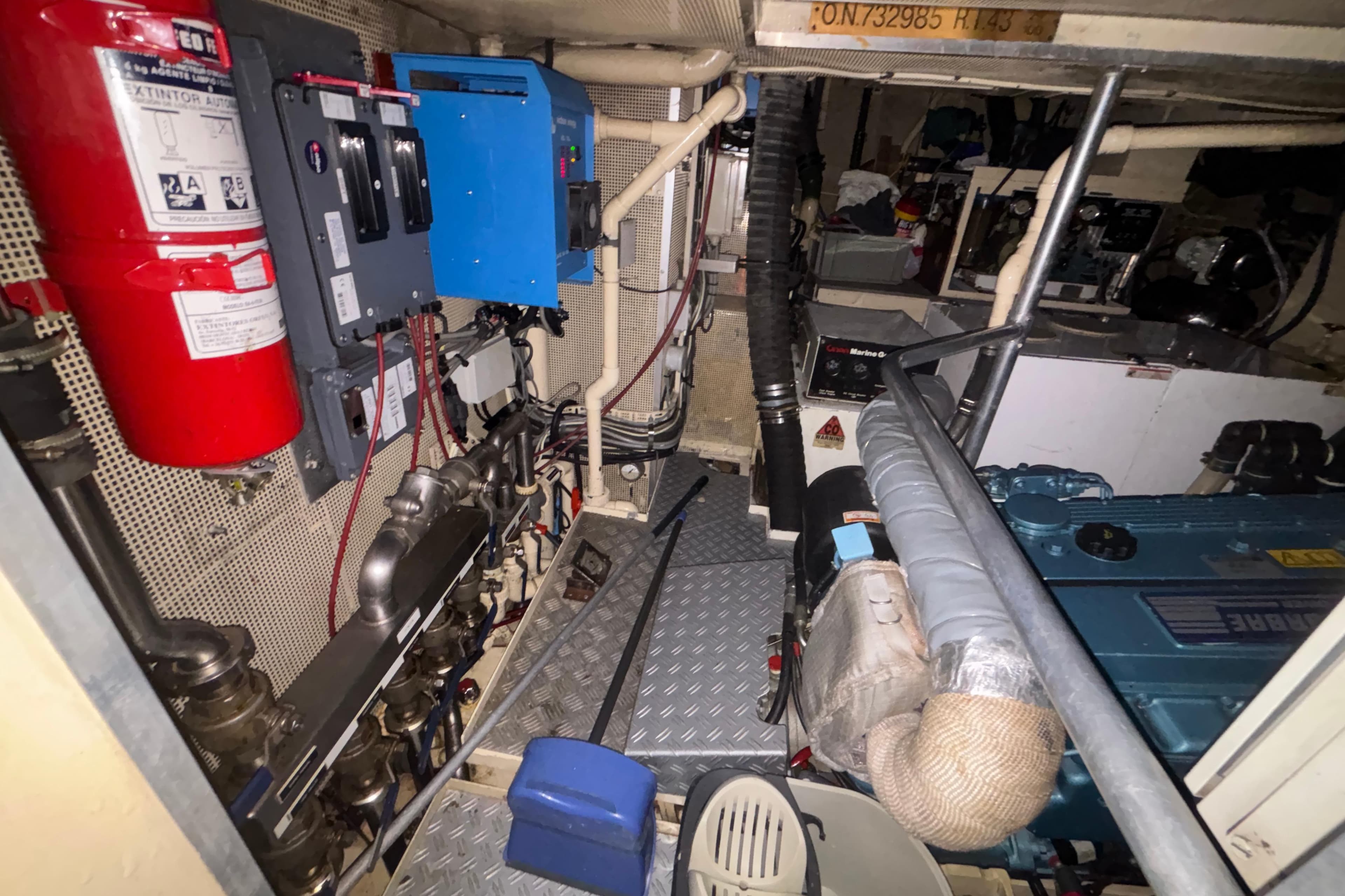 Engine room of a 1988 Jongert yacht, featuring machinery and fire safety equipment.