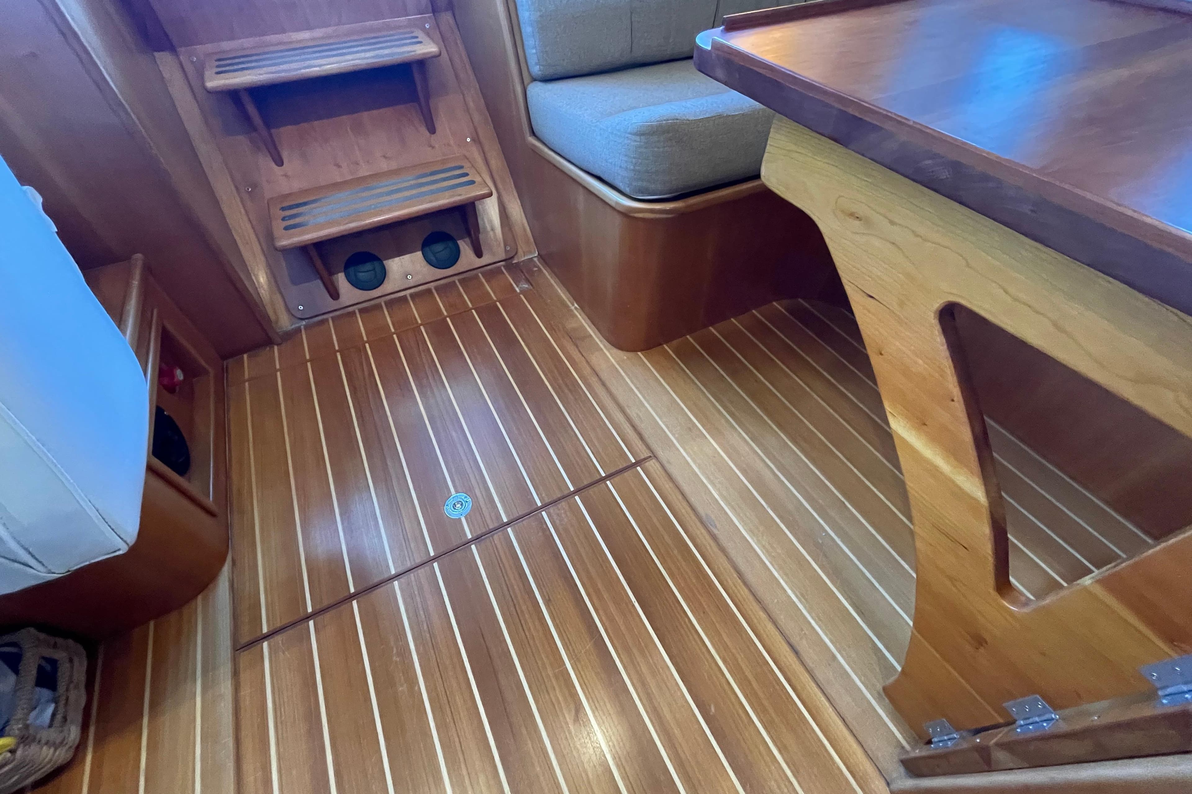 Interior of 2006 PDQ 34 Power Catamaran with wooden flooring and seating area.