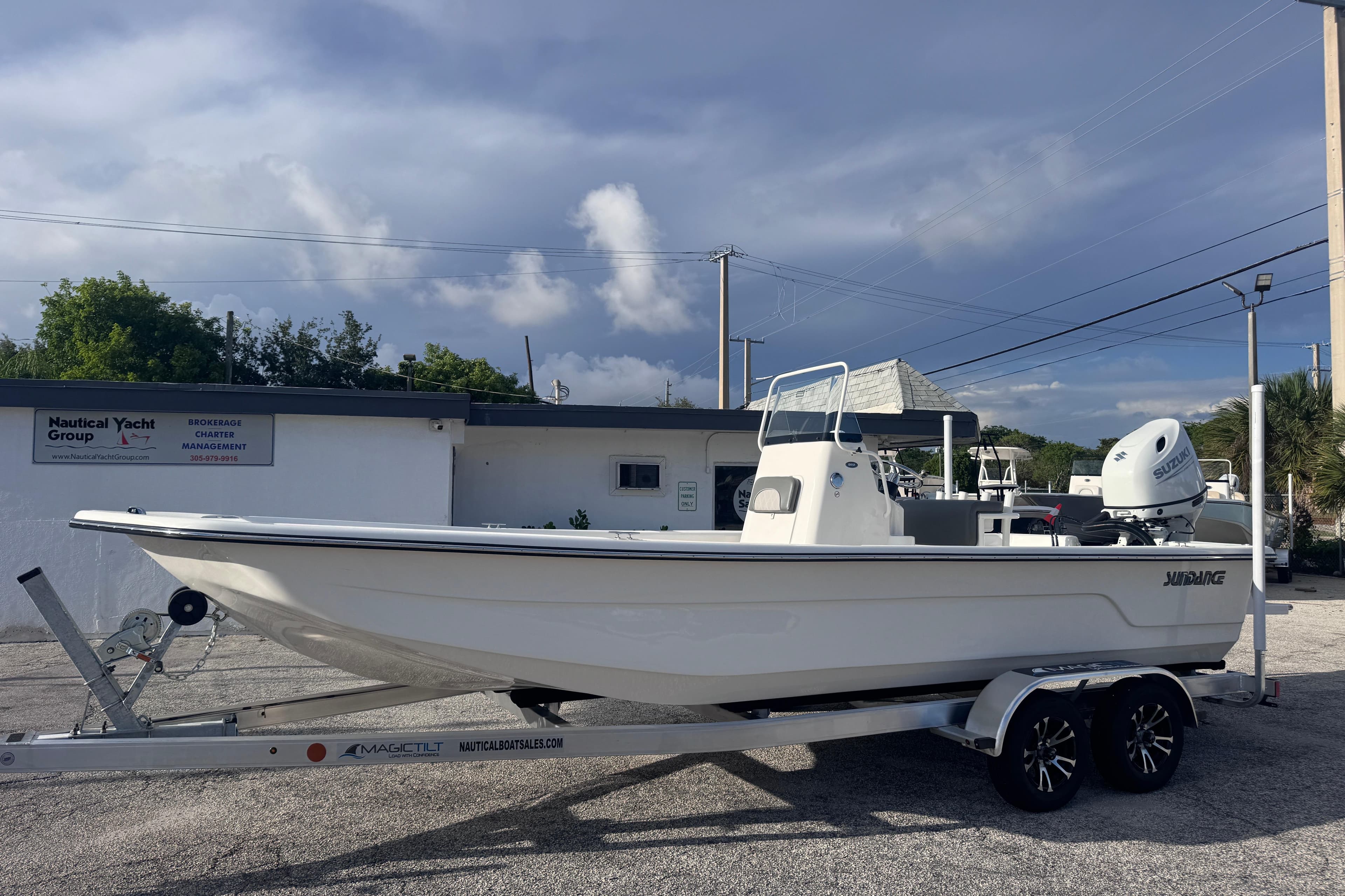 2026 Sundance B22CCR boat on trailer, parked outside Nautical Yacht Group building.