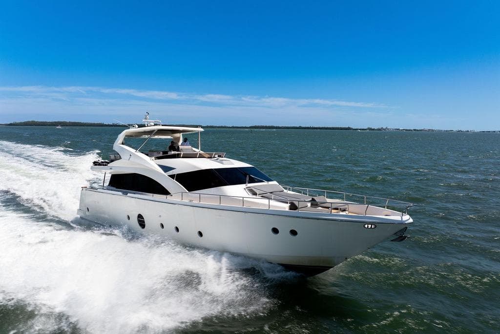 Luxury Aicon 75 yacht cruising on open water under clear blue skies, 2008 model.