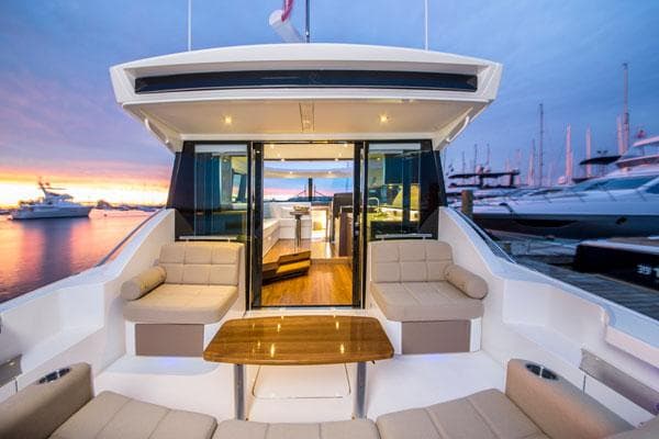 Manufacturer Provided Image: 2018 Tiara Yachts C44 Coupe luxury yacht interior at sunset, docked at marina.