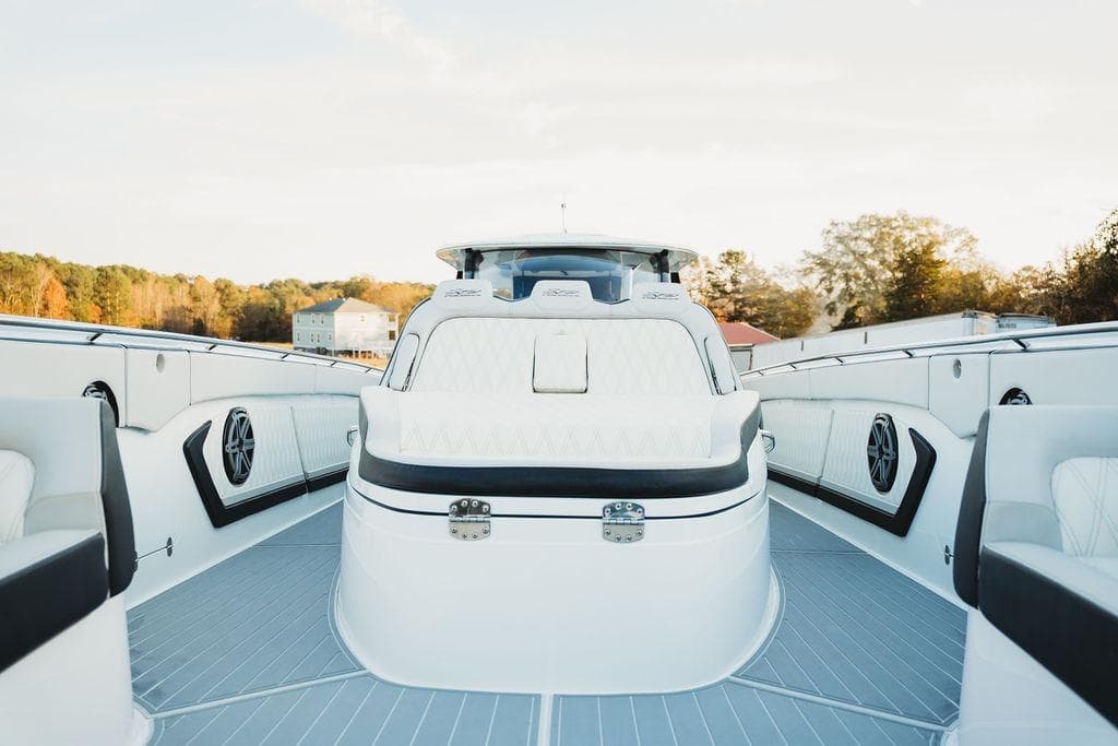 Luxurious 2018 MTI 57 yacht interior with sleek white seating and modern design.