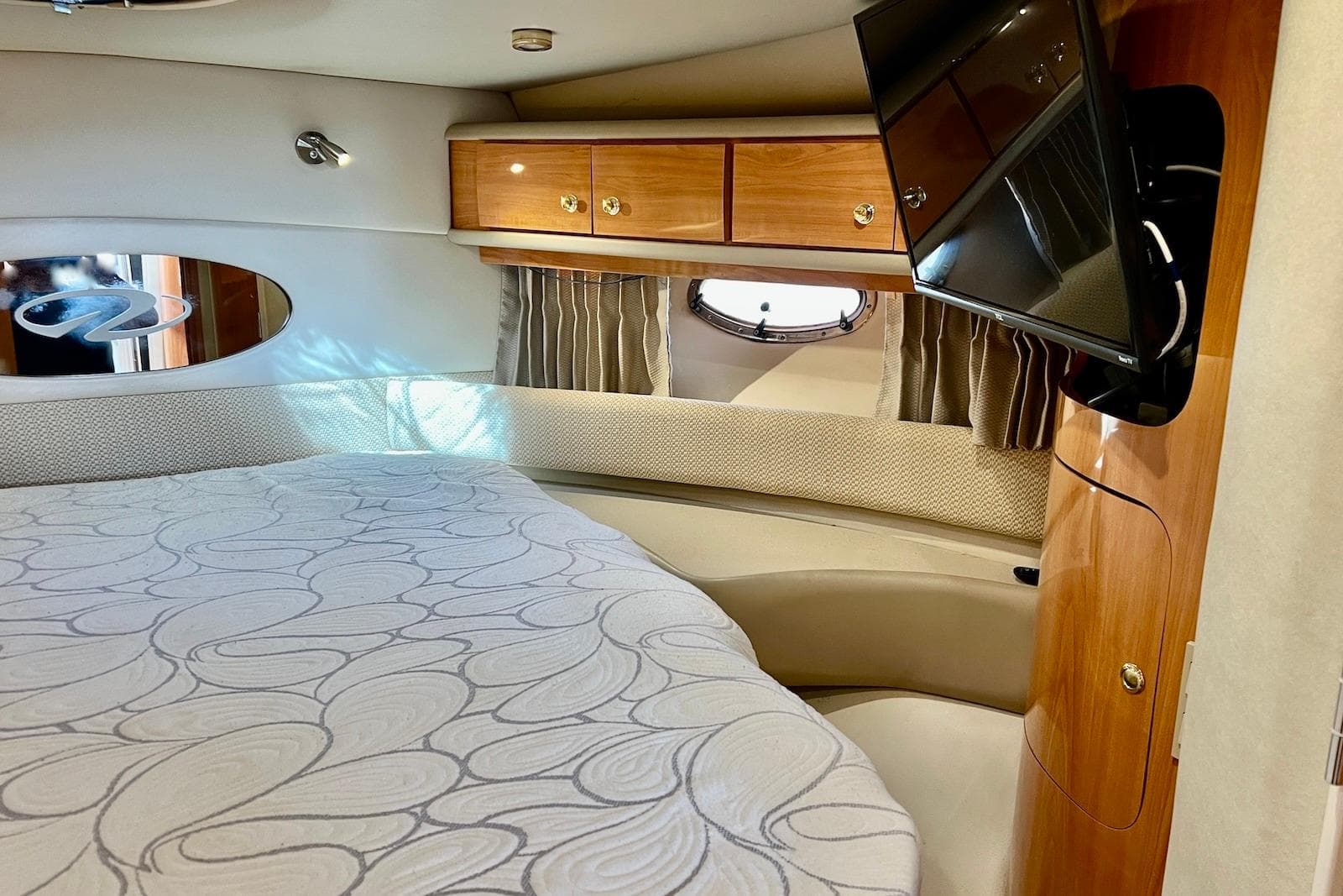 Luxurious cabin interior of 2000 Regal Commodore 4160 yacht with bed and TV.