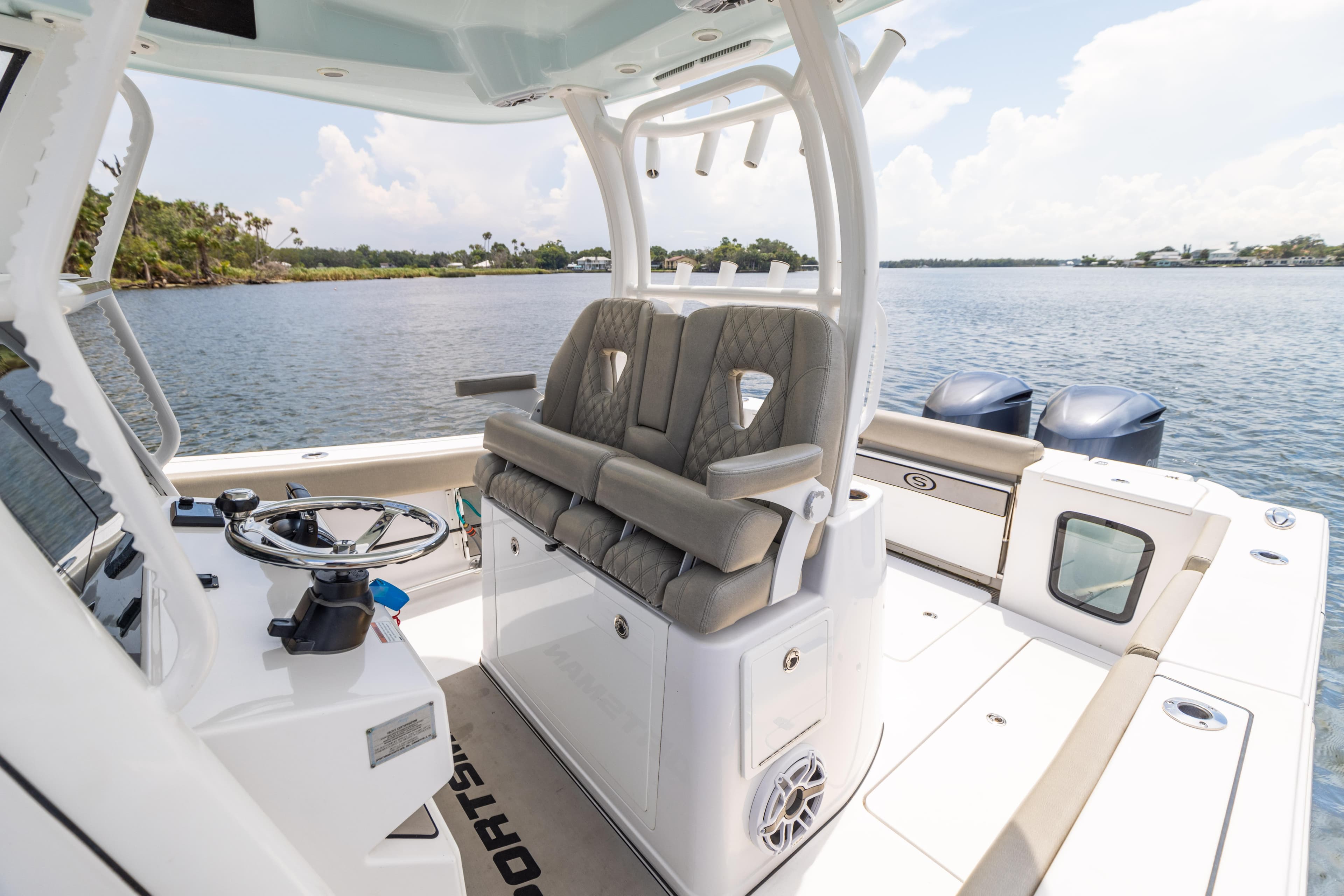 2021 Sportsman Open 302 Center Console boat interior with dual engines on a calm lake.
