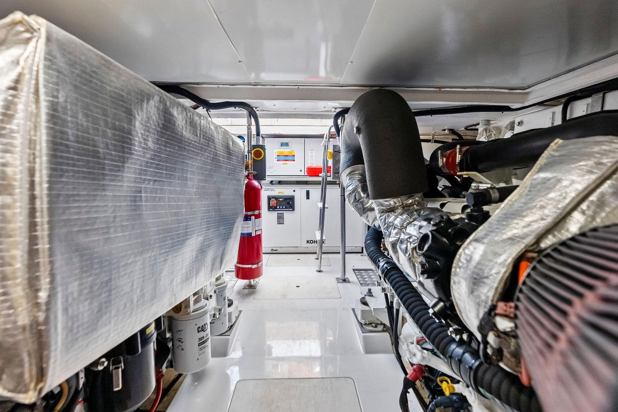 Engine room of a 2020 Azimut 66 yacht, featuring machinery and safety equipment.