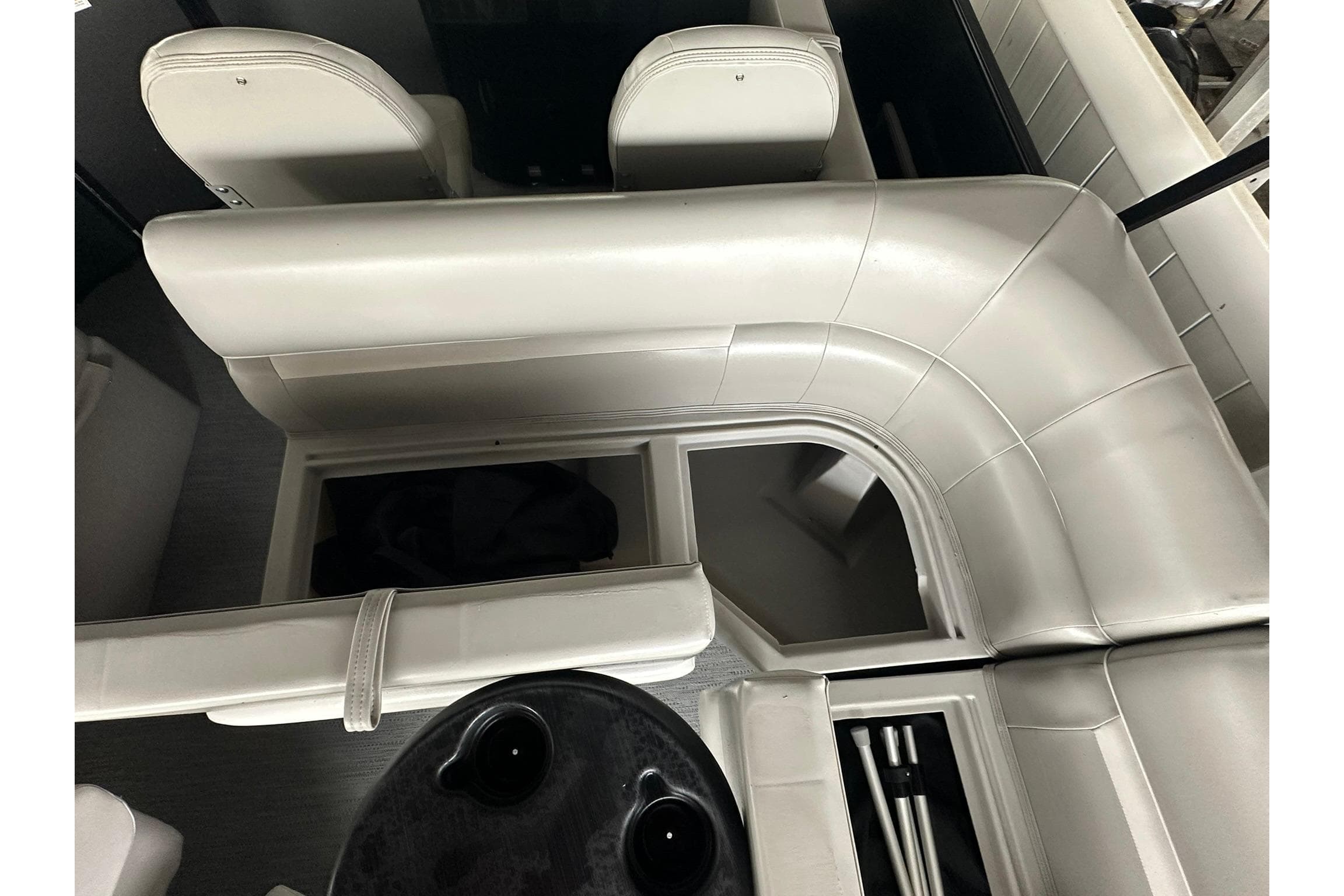 Interior of 2026 Sweetwater 2286FX boat with white seating and storage compartments.