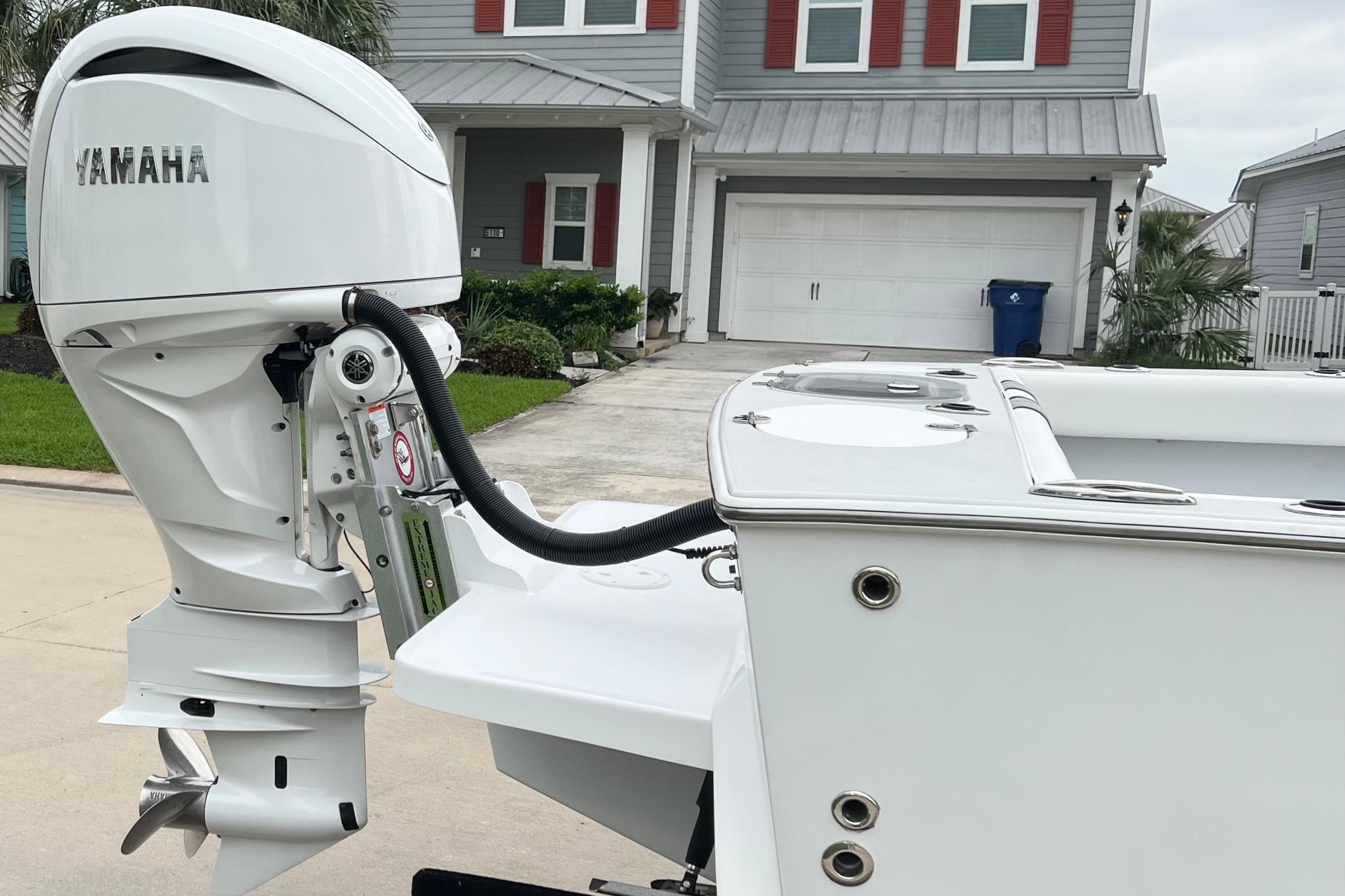 2021 Latitude Tournament Boats 25 with Yamaha outboard motor in residential driveway.