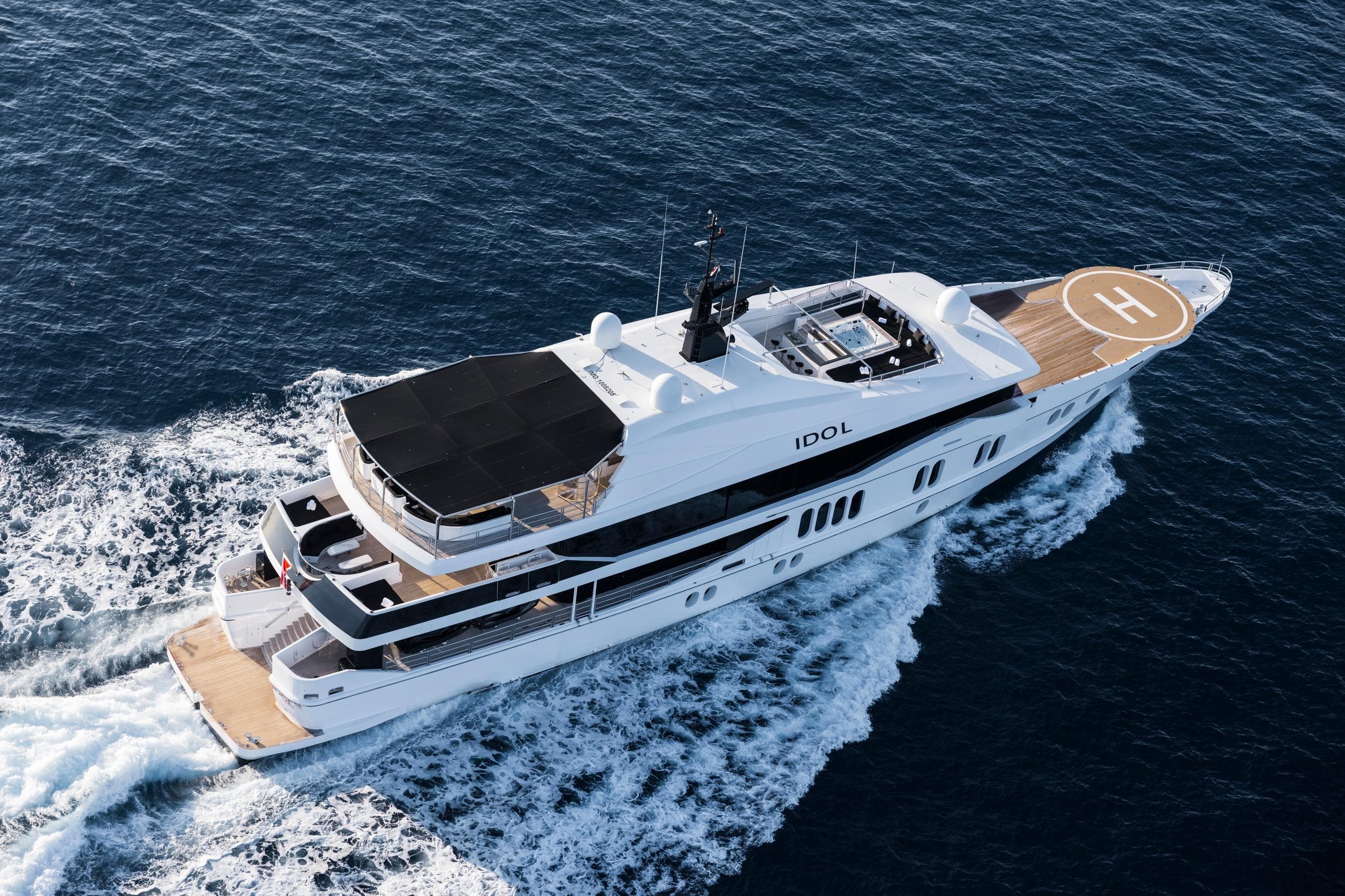 Luxurious 2007 Austal Displacement yacht cruising on open sea with helipad.