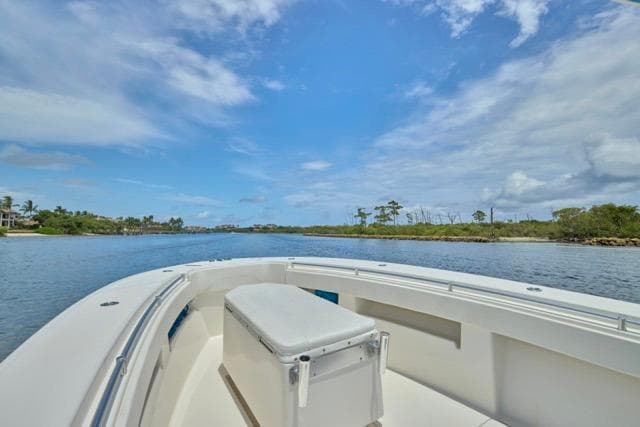 Invincible 36 boat on calm waters under a clear blue sky, 2015 model.