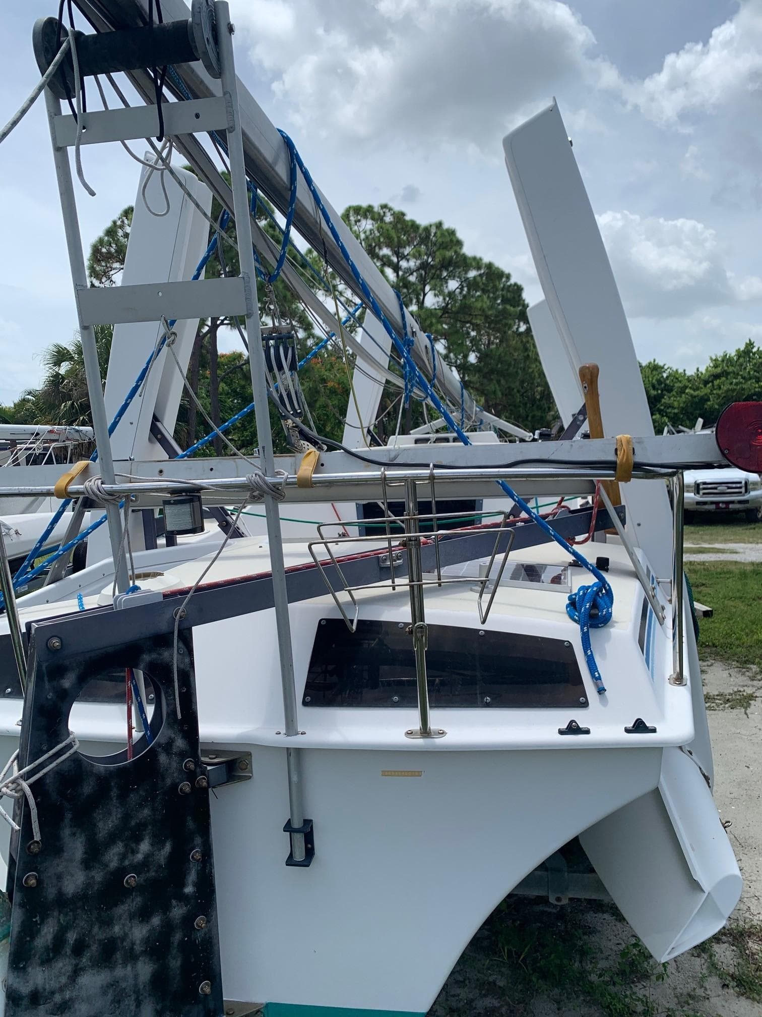 1991 Corsair F27 trimaran on a trailer outdoors.