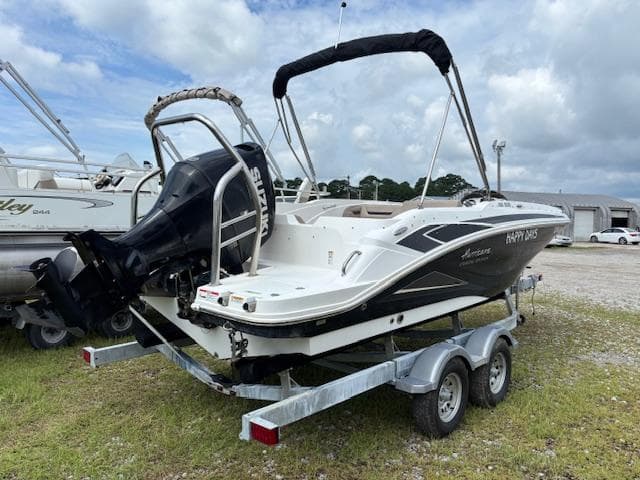 2022 Hurricane SS 205 OB boat on trailer, parked outdoors under cloudy sky.