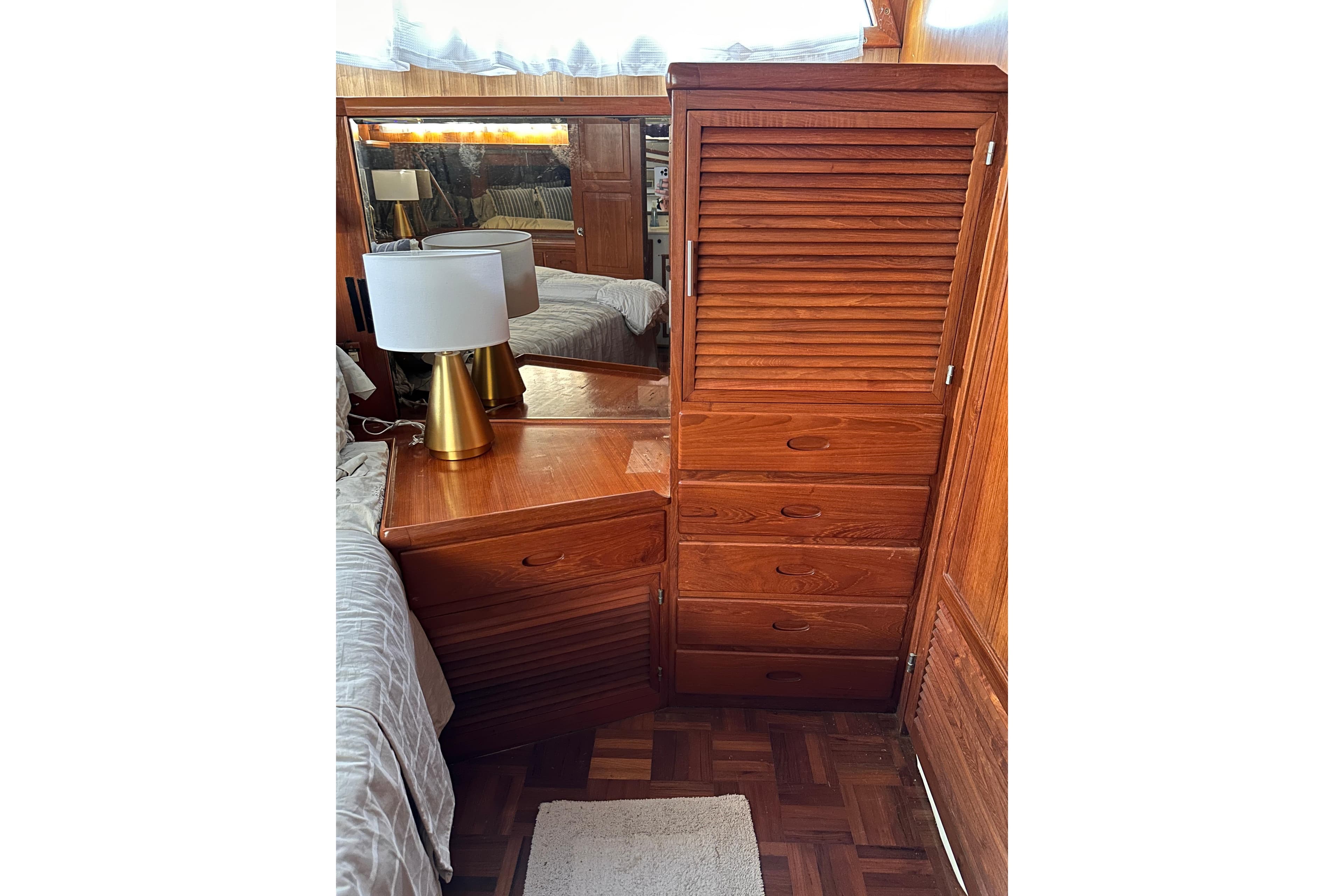 Wooden cabin interior with dresser and lamp on Marine Trader 47 Tradewinds, 1987 model.
