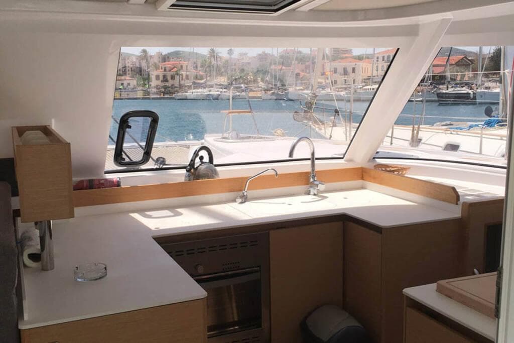 Modern kitchen interior of 2016 Nautitech 40 Open catamaran with marina view.