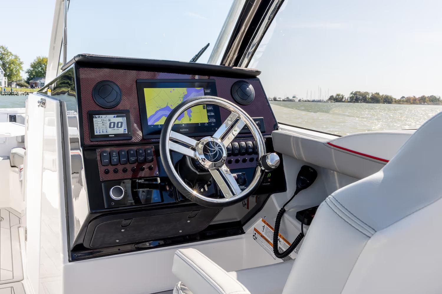 Manufacturer Provided Image: 2026 Solara S-250 DC boat dashboard with navigation screen and steering wheel.