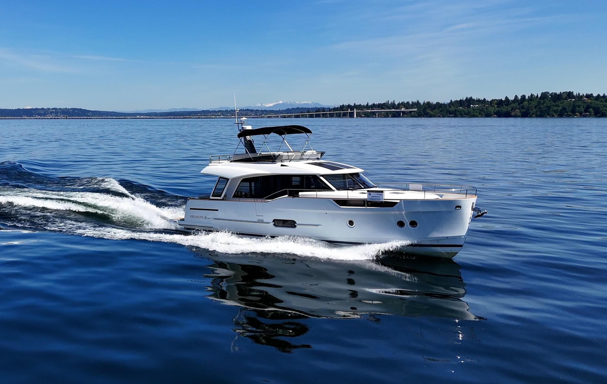 2024 Greenline 48 Fly yacht cruising on a calm blue sea.