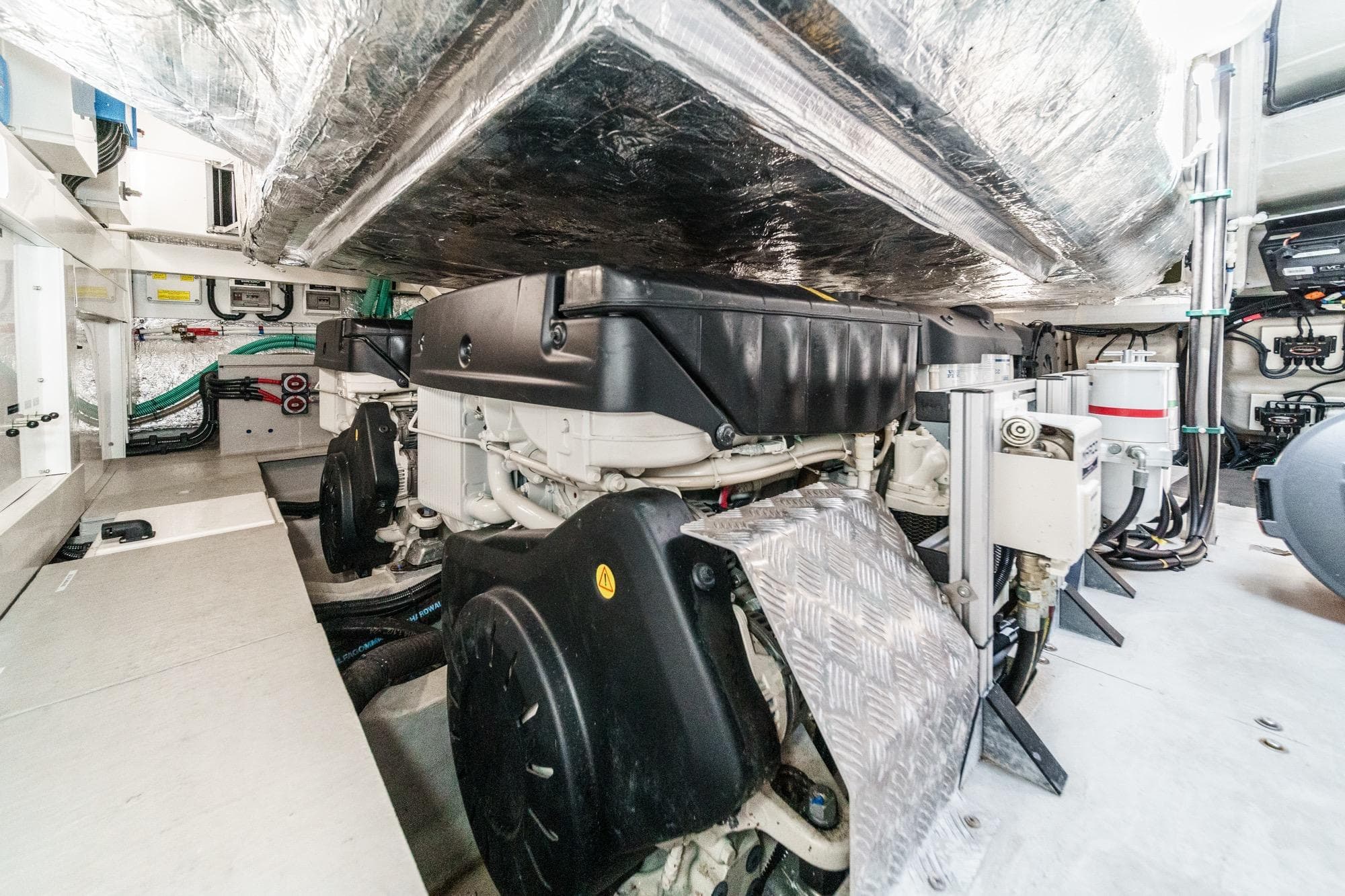 Engine room of 2023 Sunseeker 65 Sport Yacht, showcasing advanced mechanical systems.