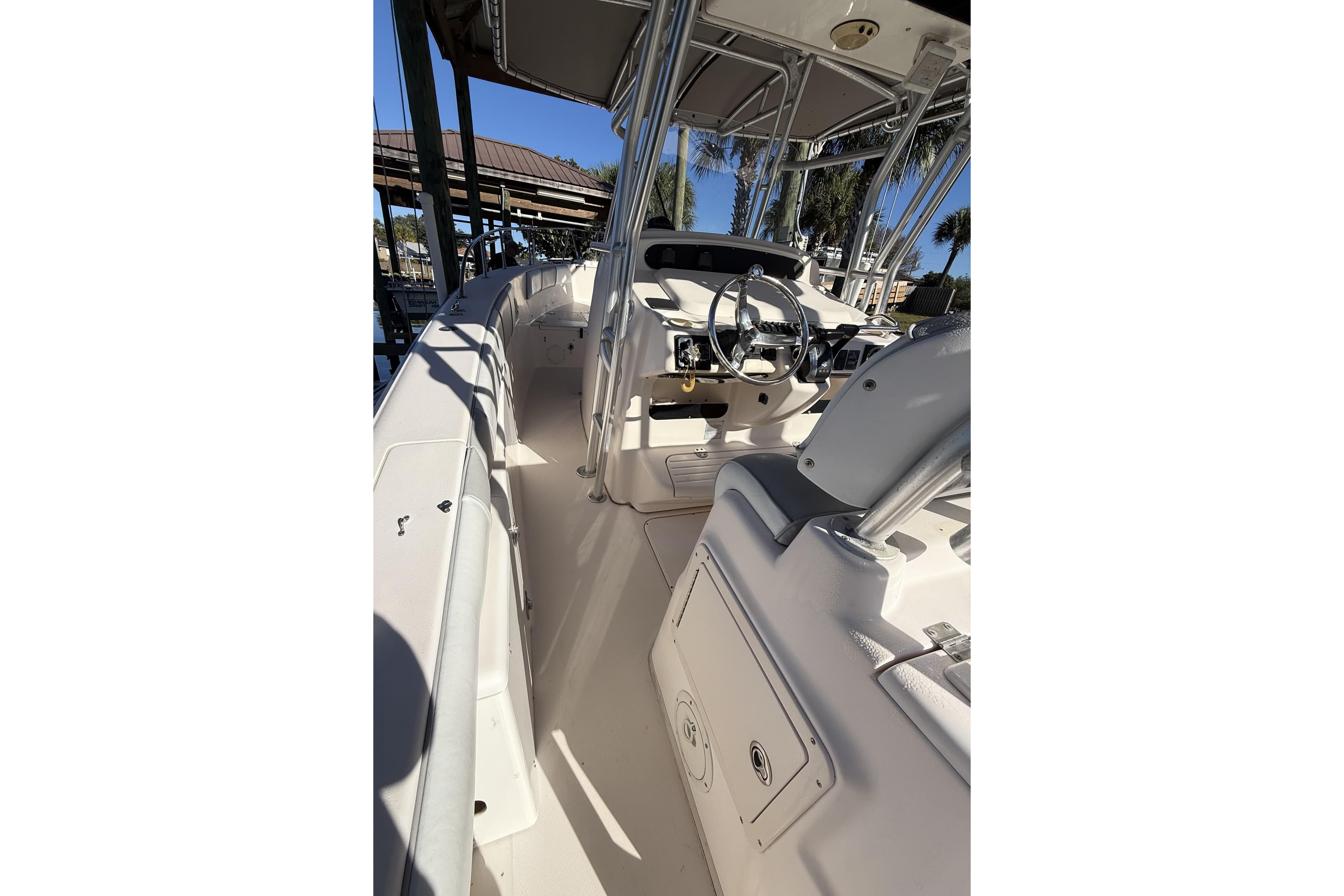 2005 Grady-White Bimini 306 boat interior with steering wheel and seating.