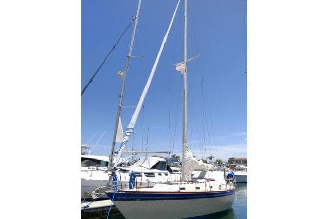 1978 Tartan 37 sailboat docked in marina under clear blue sky.