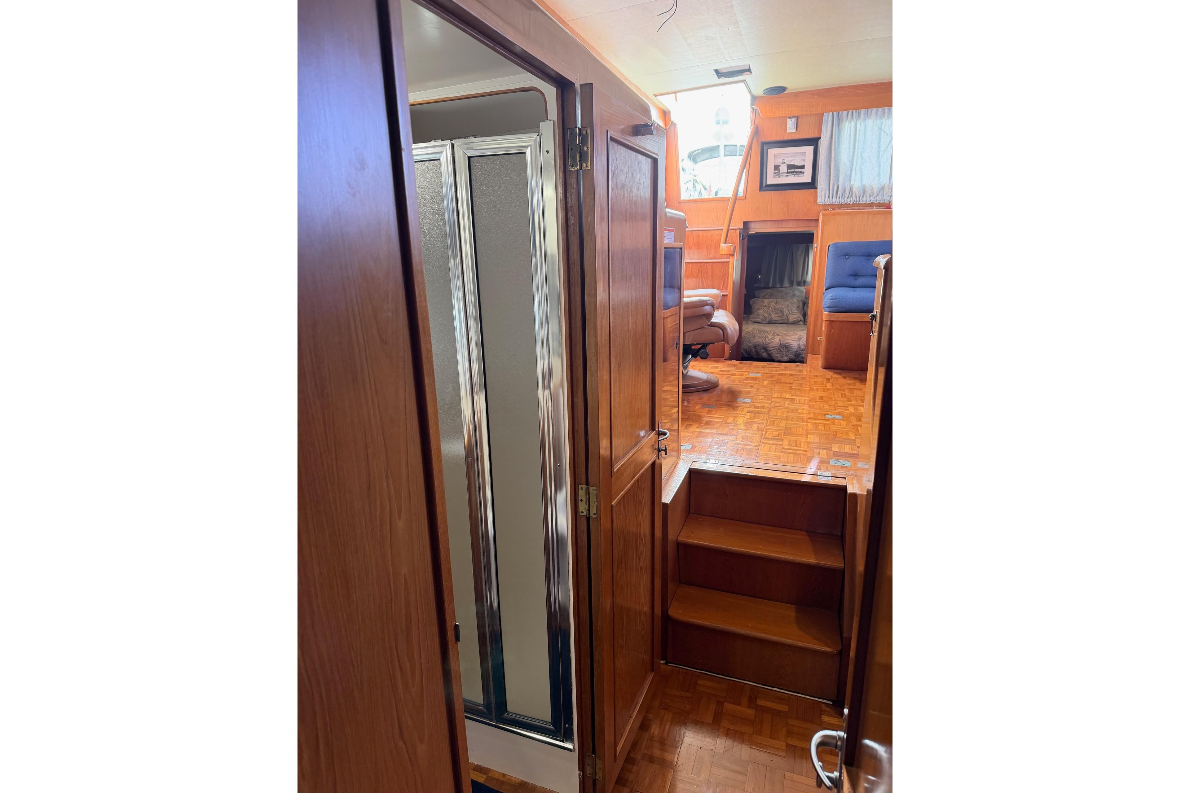 Interior view of 1988 Ocean Alexander 42' yacht with wooden finishes and seating area.