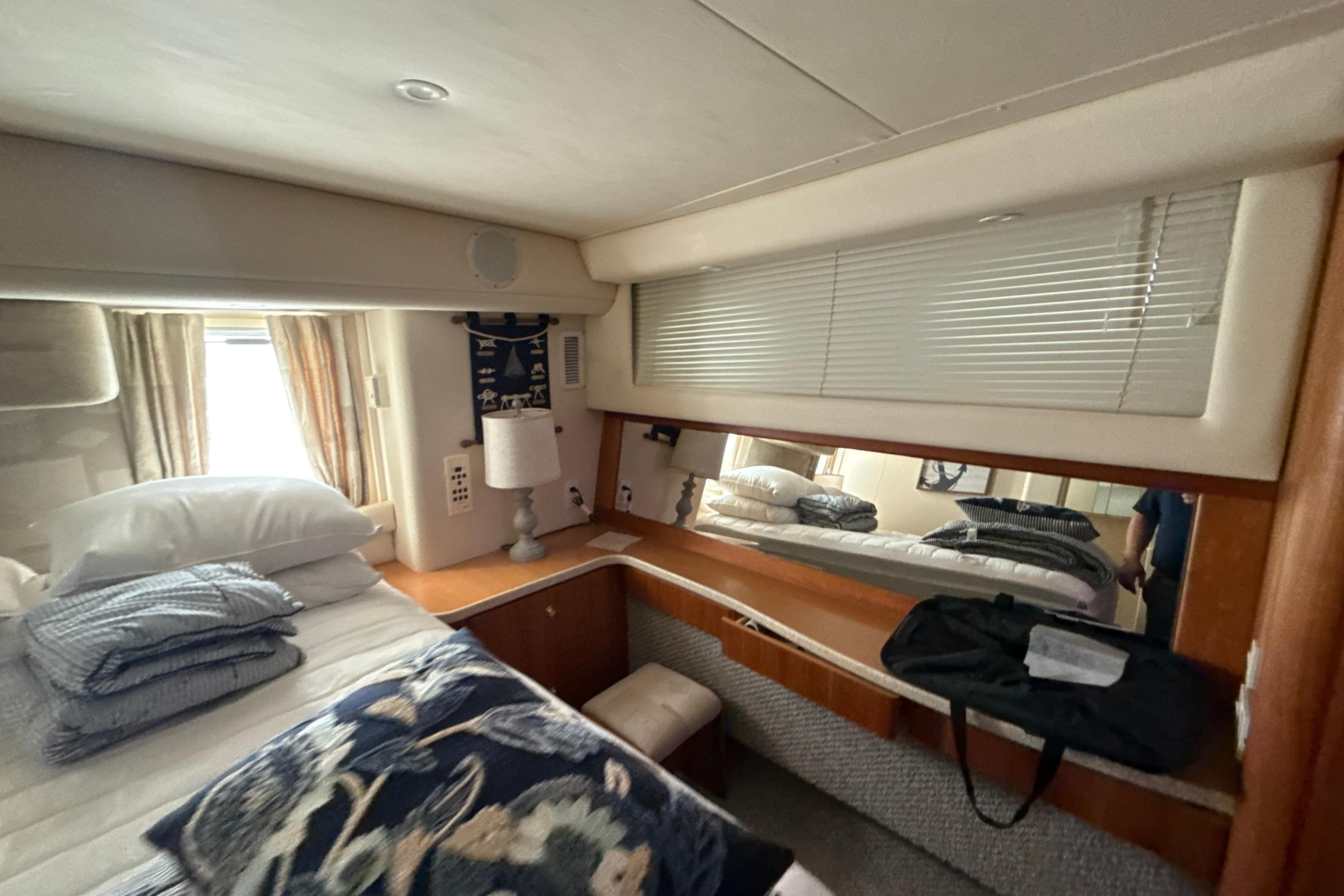 Cozy bedroom interior of 1999 Silverton 422 Motor Yacht with bedding and decor.