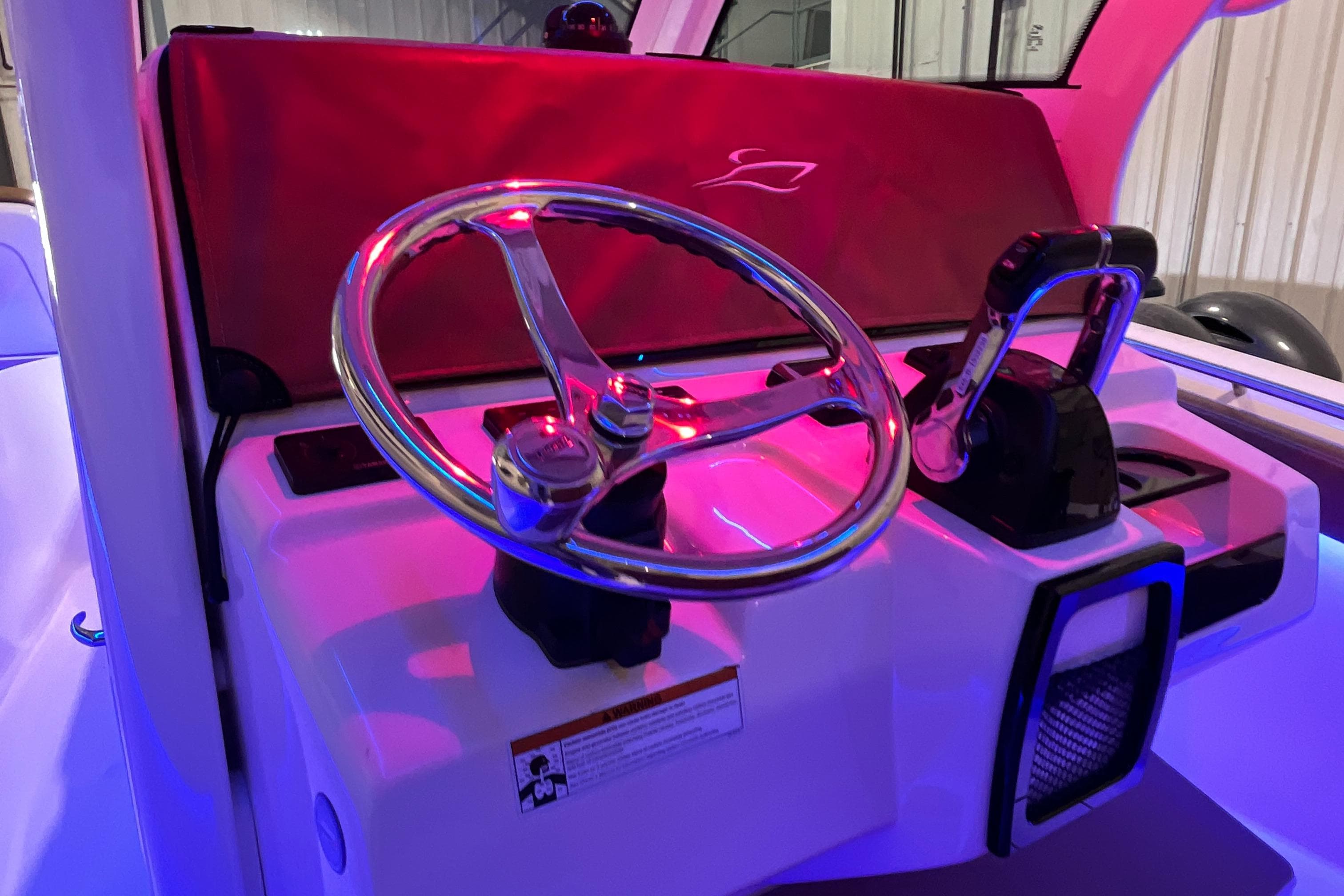 Steering console of 2021 Scout 305 LXF boat with illuminated controls.