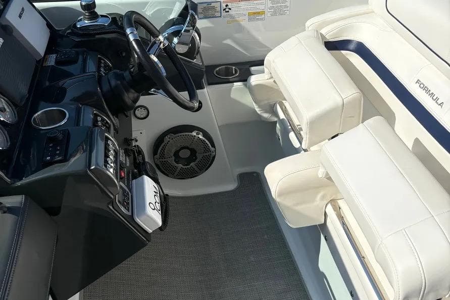 Interior of 2015 Formula 350 Crossover Bowrider, featuring steering wheel and white seating.