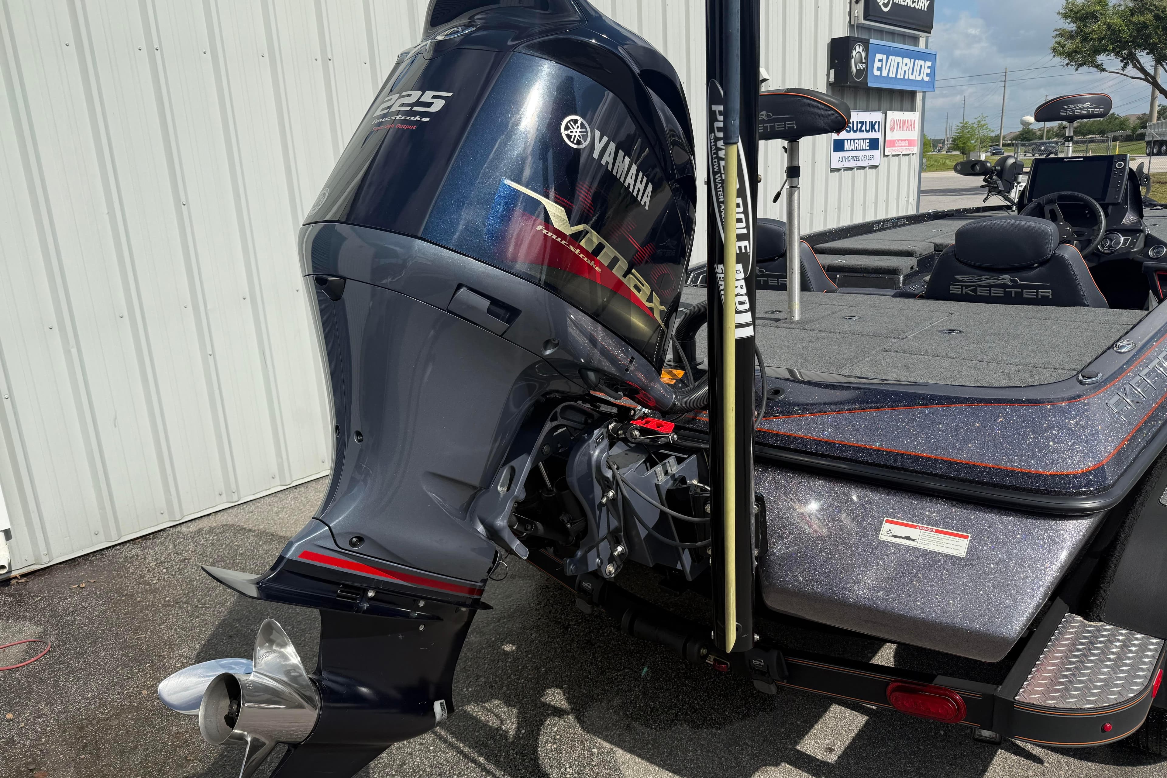 2019 Skeeter ZX225 boat with Yamaha VMAX engine, parked outside a marine dealership.
