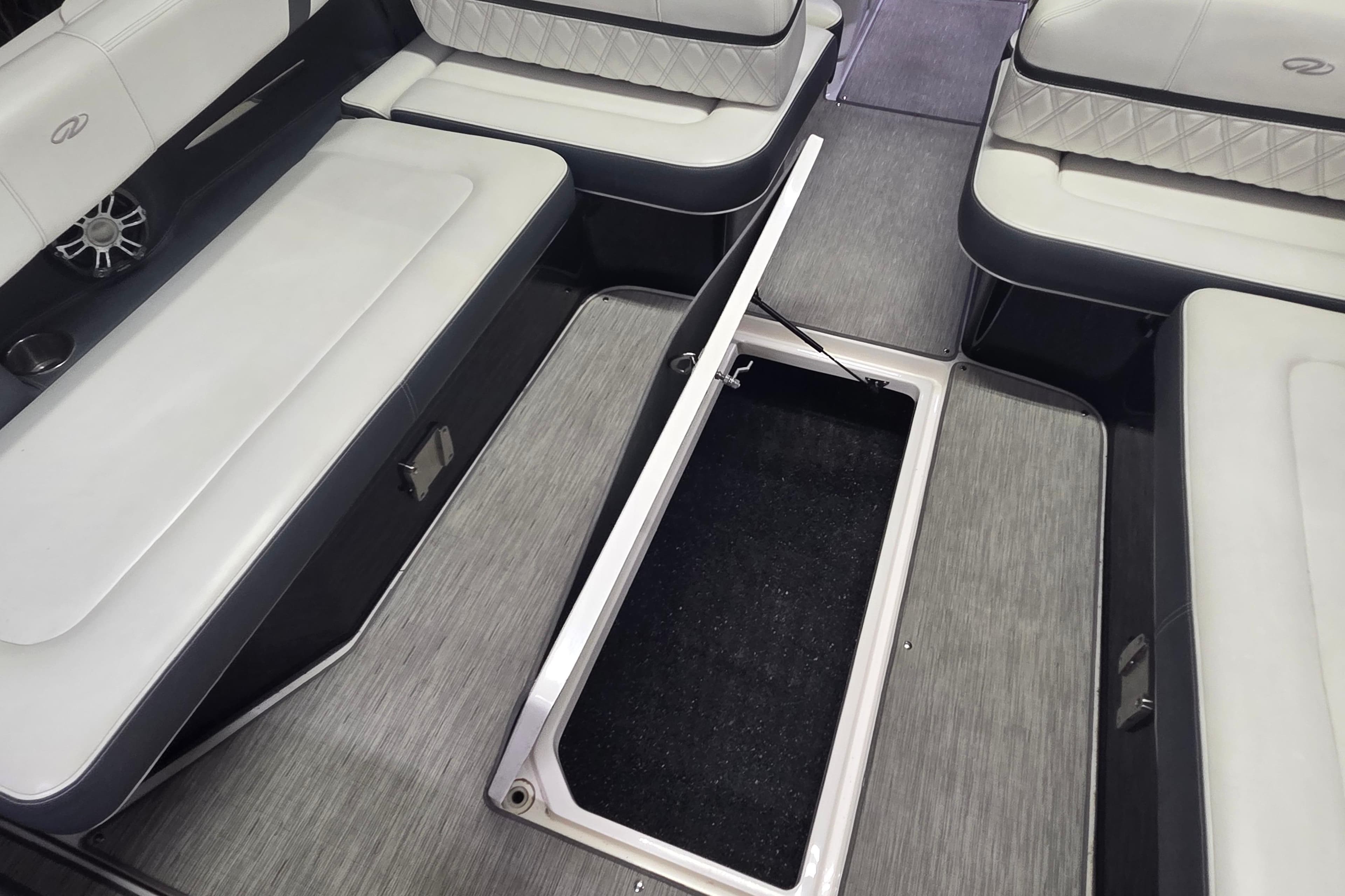 2019 Regal 29 OBX boat interior with open storage compartment and cushioned seating.