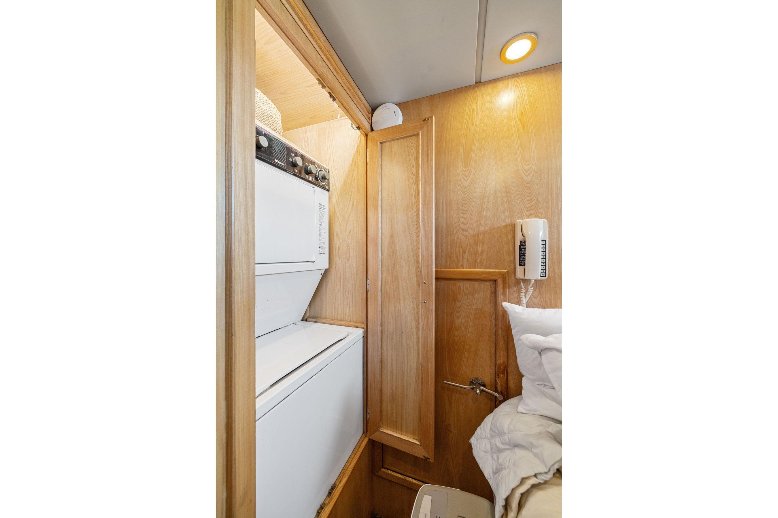 Laundry area in 1991 Ocean Alexander 520 Pilothouse yacht with stacked washer and dryer.