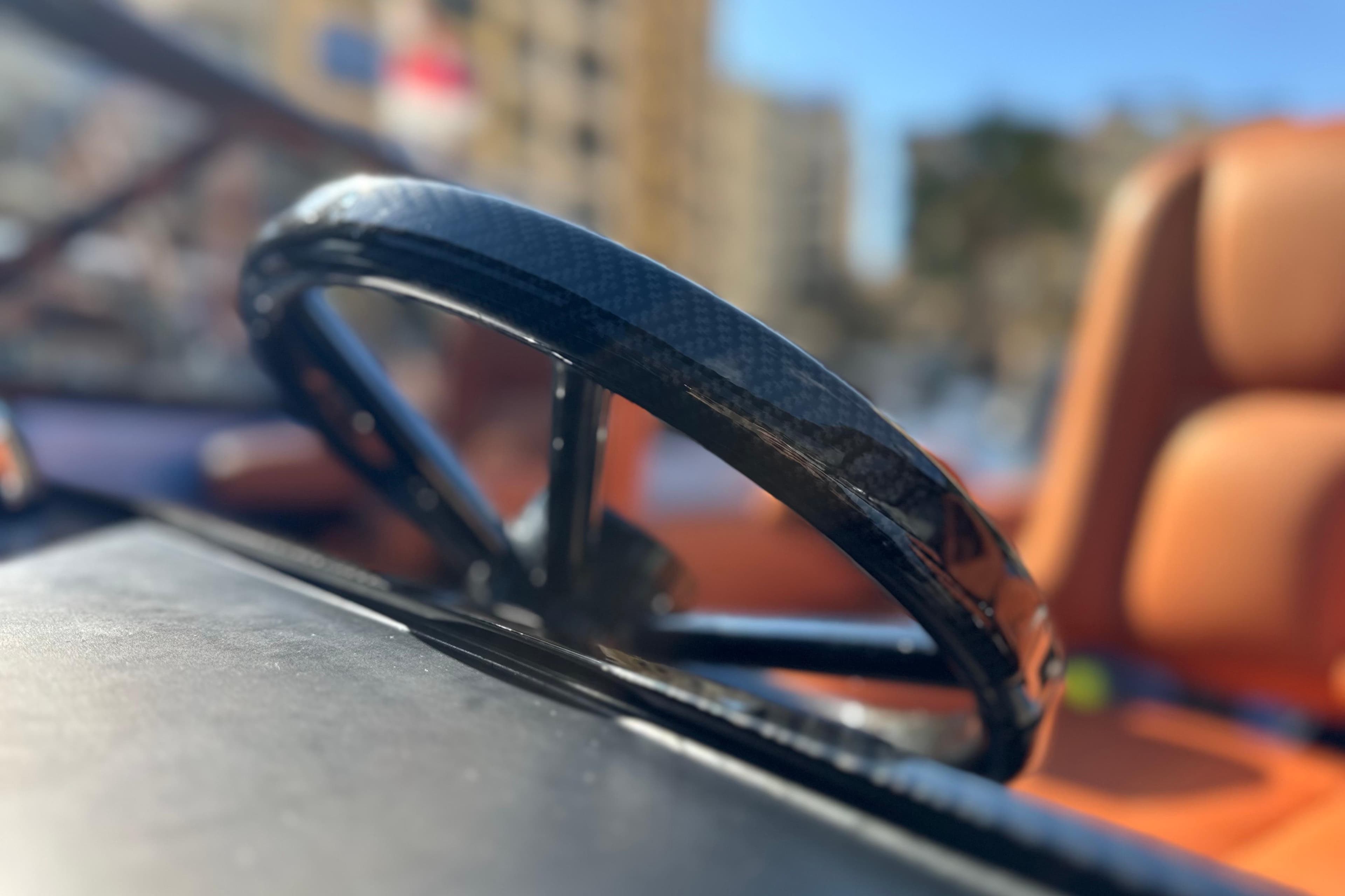 Close-up of a 2014 Wajer 38 steering wheel with blurred background.