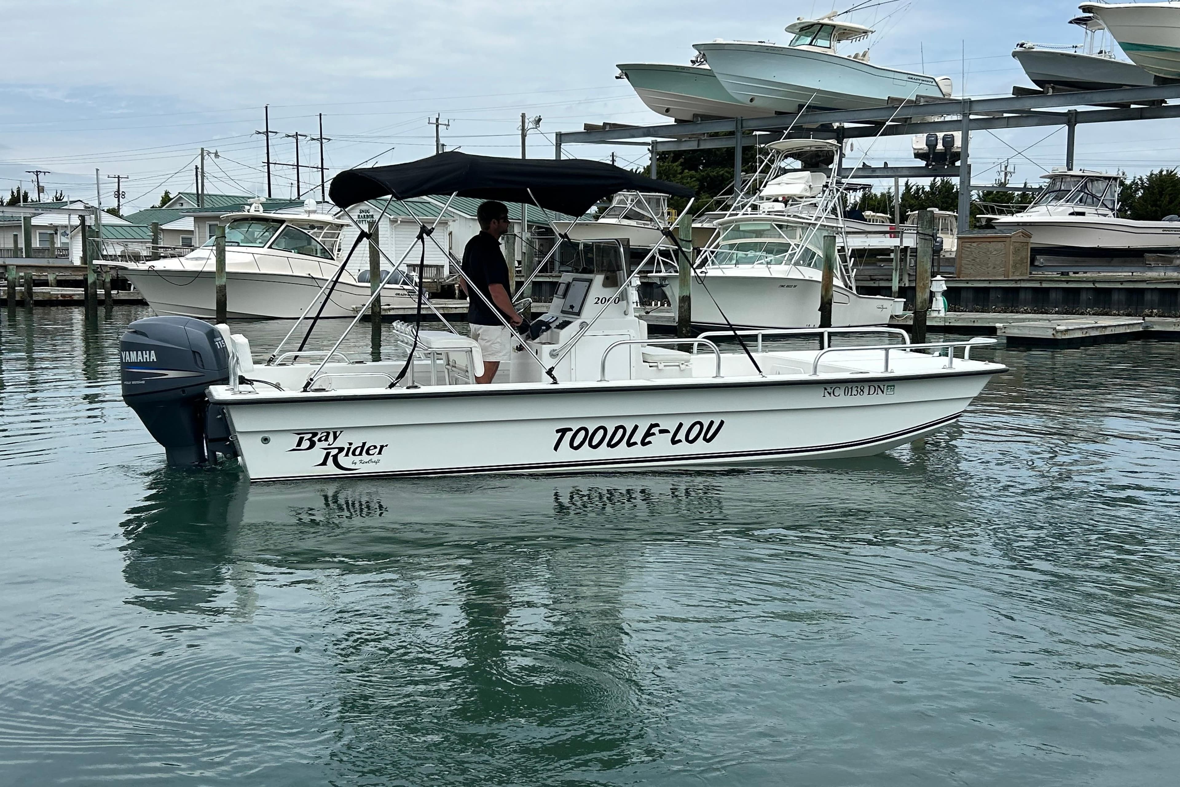 2009 KenCraft 2060 Bay Rider boat named "Toodle-Lou" docked in a marina.
