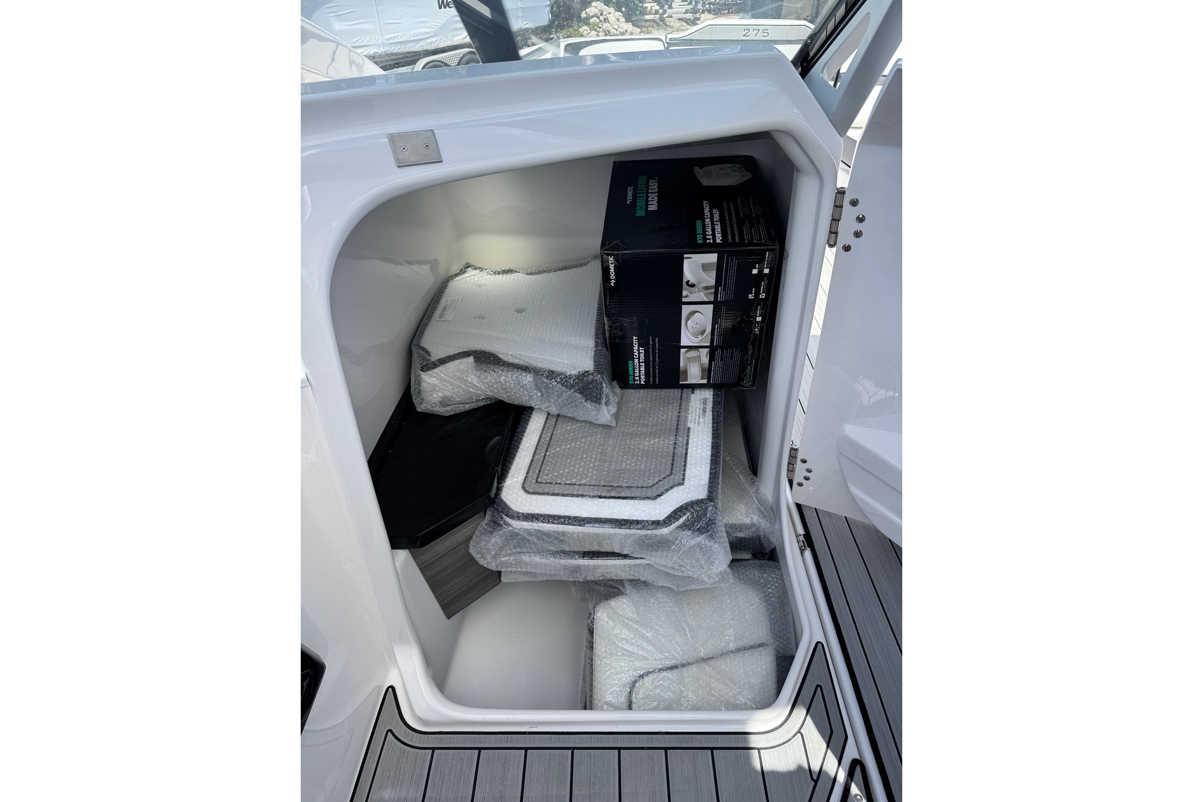 Storage compartment of 2026 Yamaha Boats 275SD with packaged accessories inside.