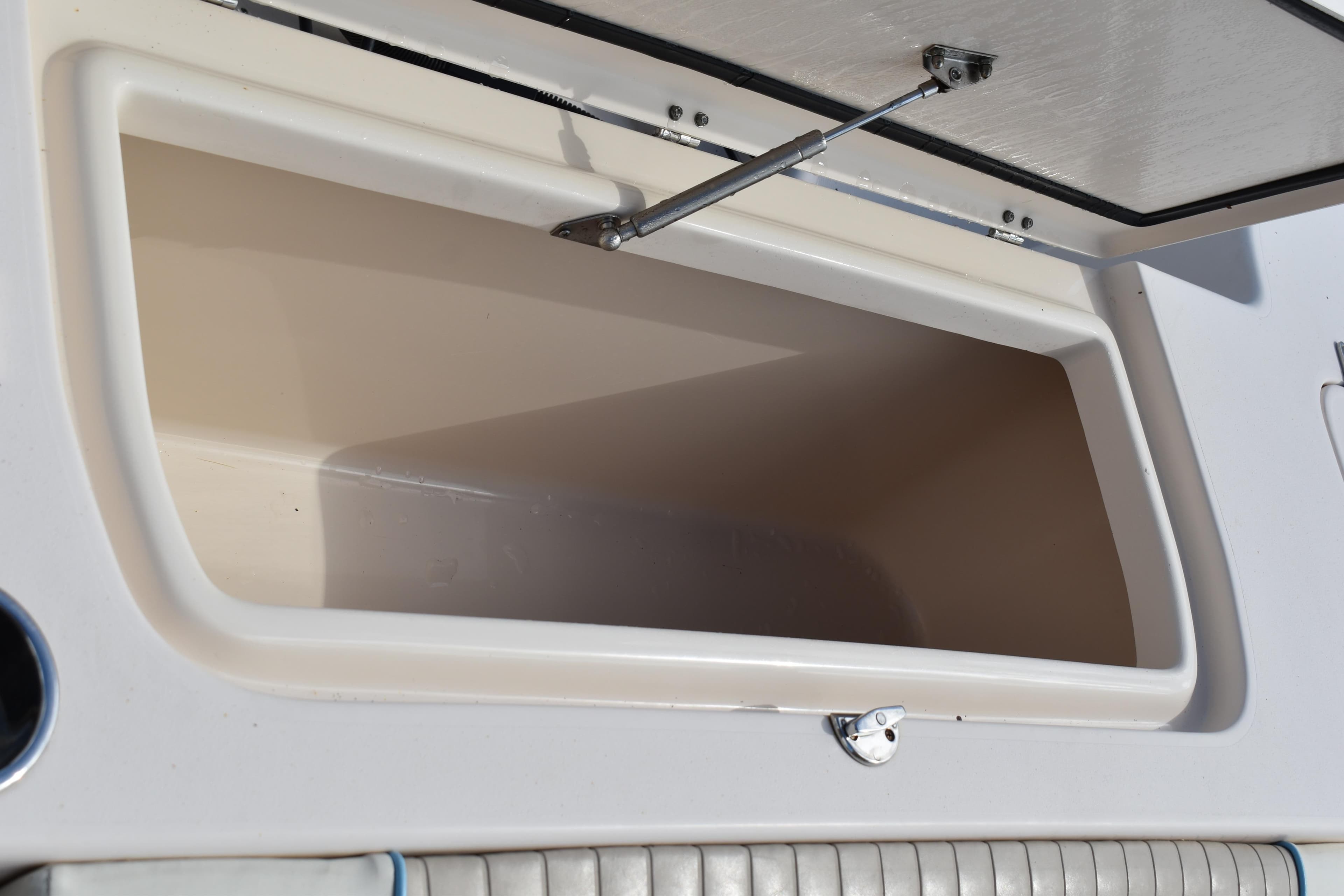 Open storage compartment on a 2012 Grady-White Canyon 271 boat.
