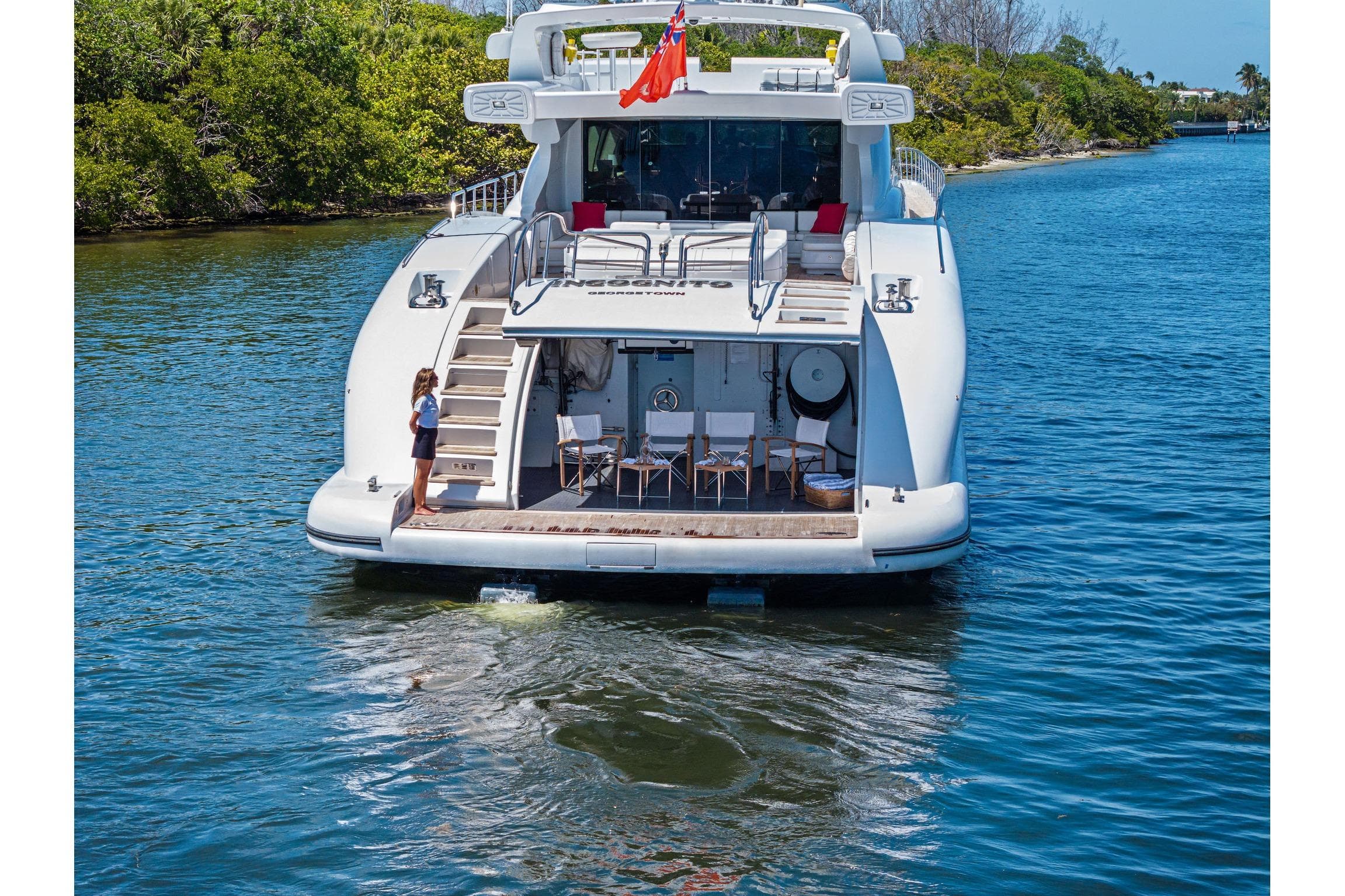 Luxury 2005 Mangusta 130 yacht on water, featuring spacious deck and elegant design.