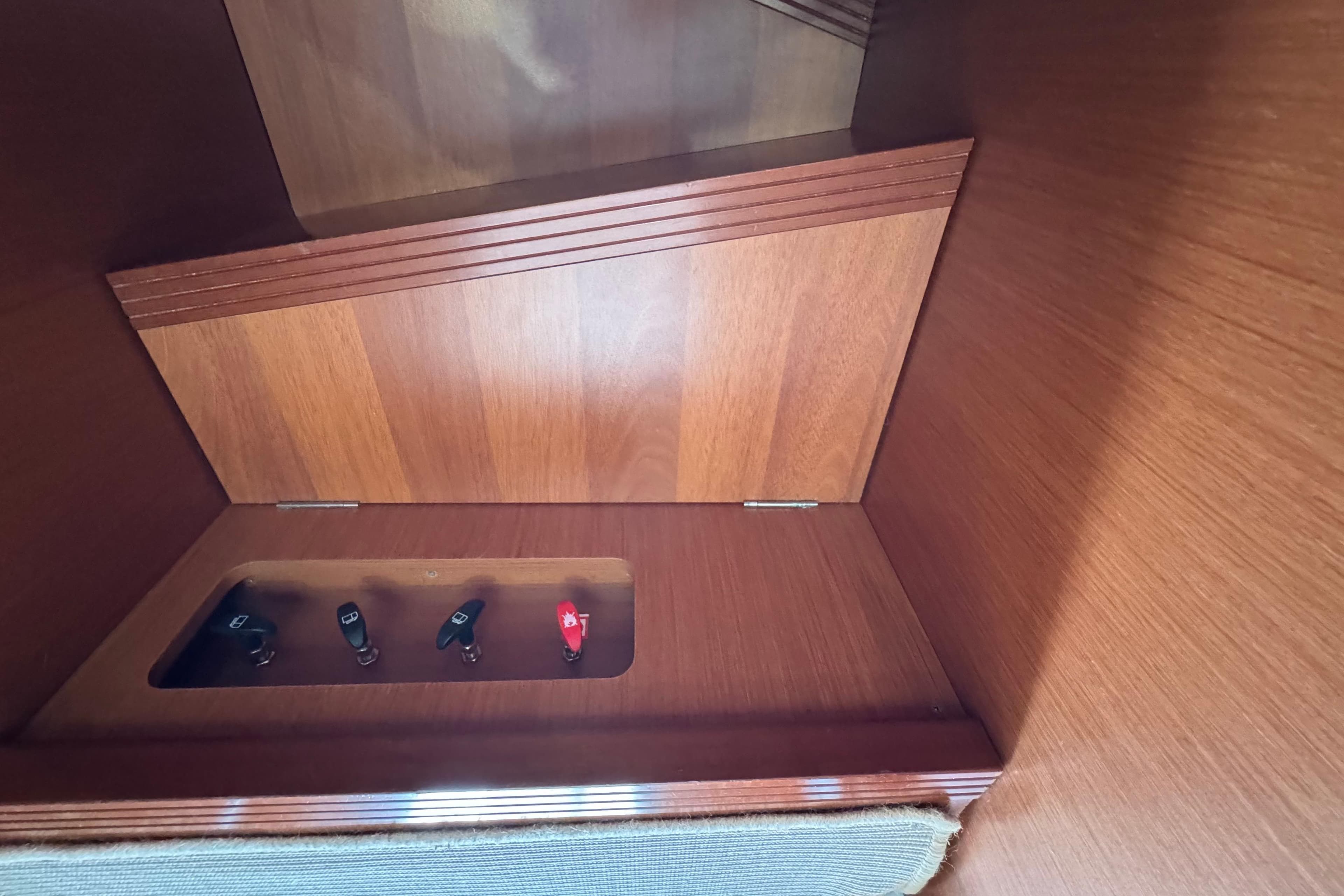 Interior view of a 2014 Beneteau Swift Trawler 44, showcasing wooden paneling and control switches.
