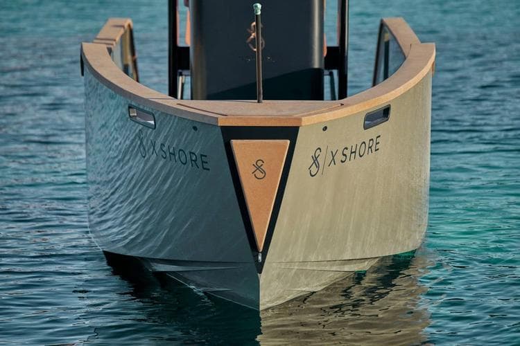 2023 X Shore Eelex 8000 electric boat on clear blue water.