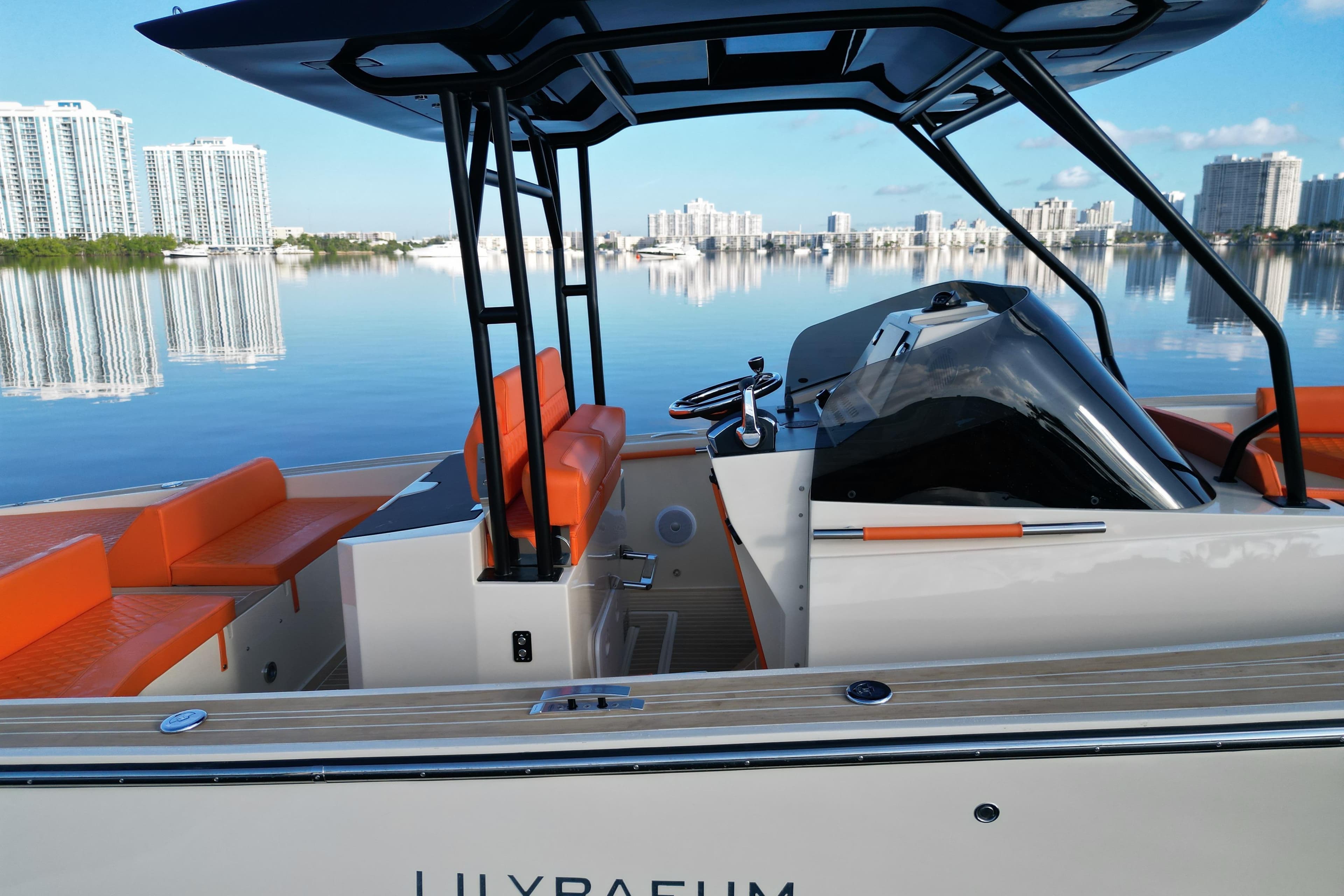 2026 Lilybaeum Lipari 31 boat with orange seating, sleek design, and waterfront cityscape.