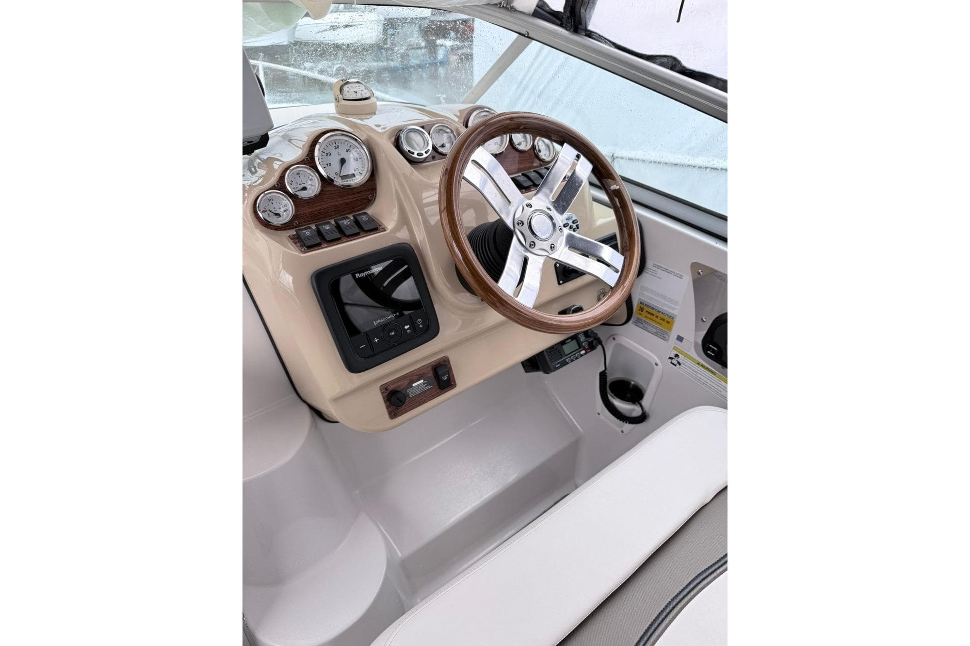 2014 Glastron/Carlson GS 259 boat dashboard with steering wheel and gauges.