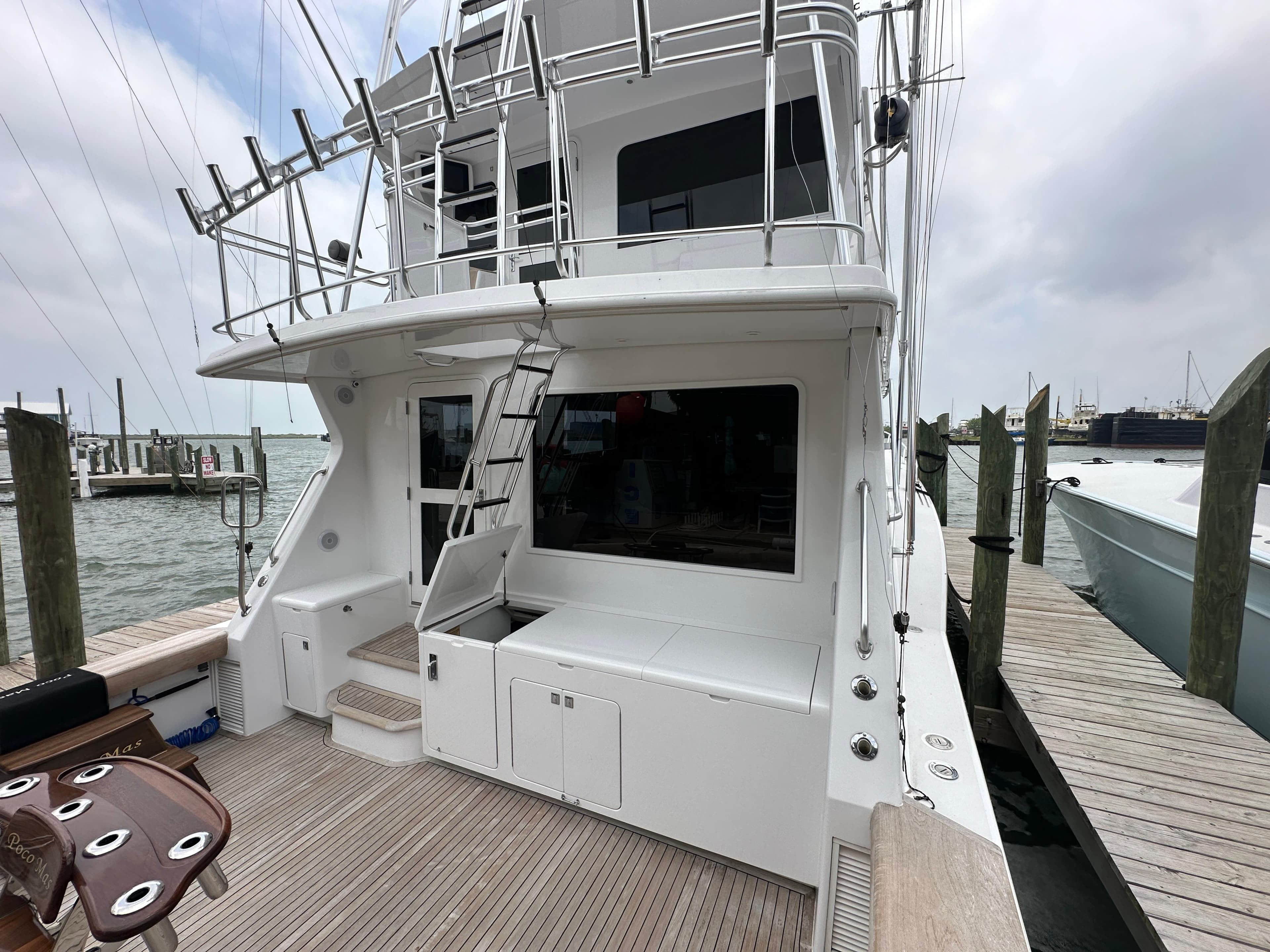 1996 Donzi Custom Enclosed Flybridge yacht docked at a marina.