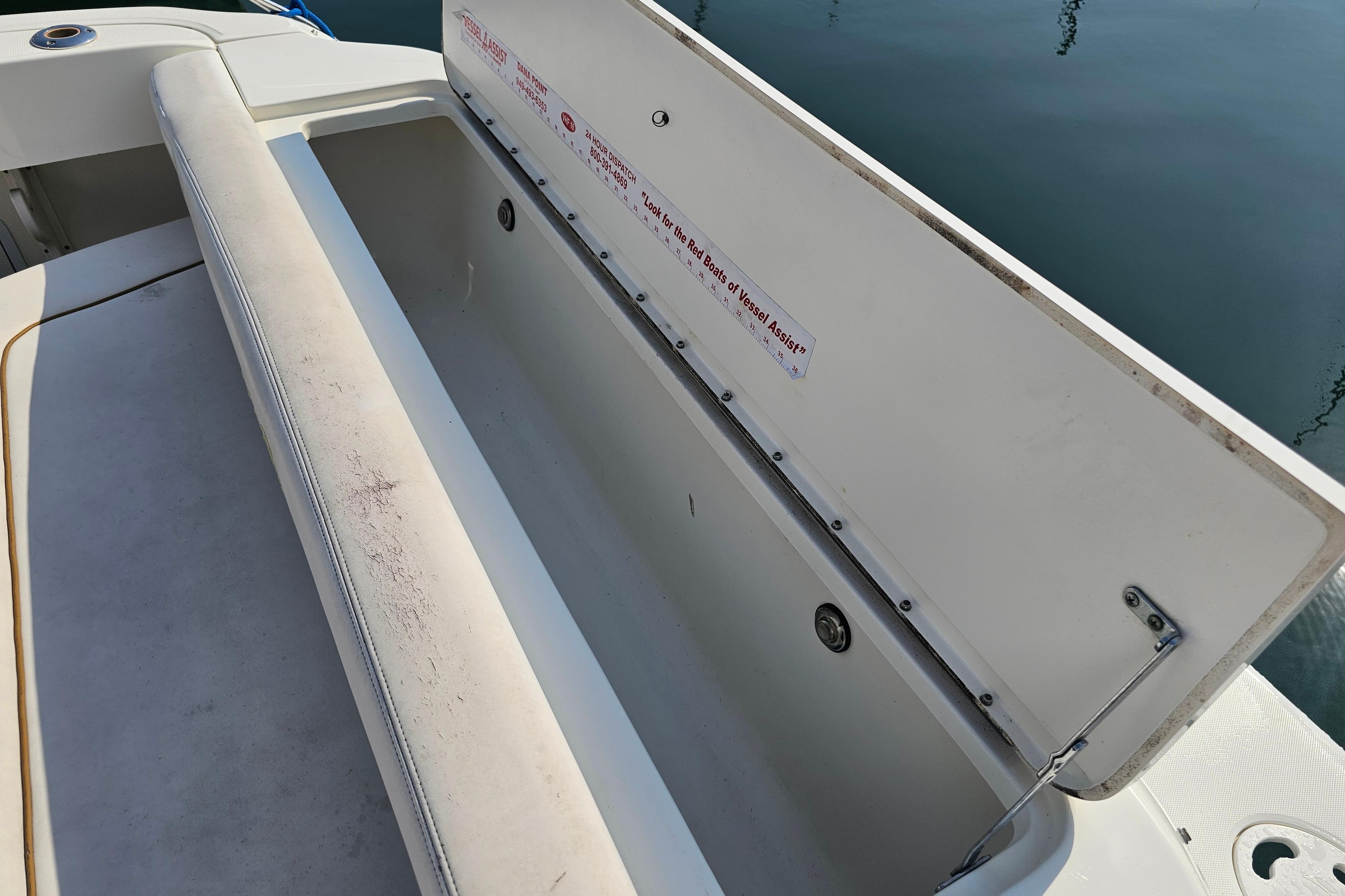 Open storage compartment on 2001 Sea Ray 290 Amberjack boat, showing interior details.