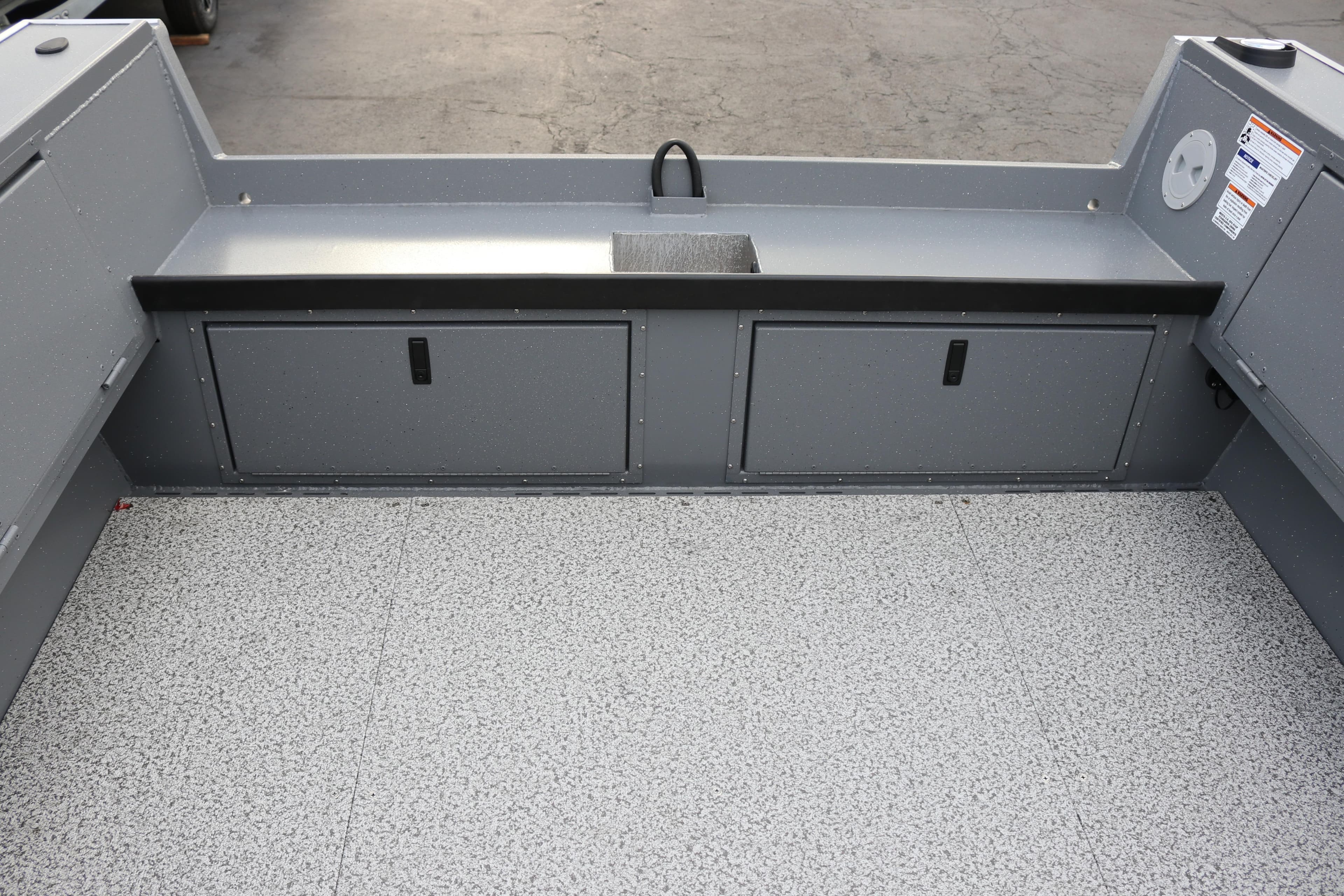 2026 Alumaweld Columbia 23 boat interior with storage compartments and non-slip flooring.