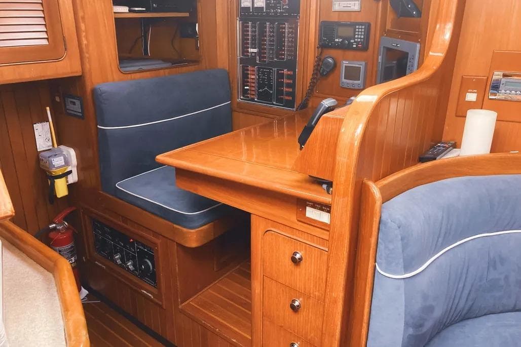Interior of a 1999 Hylas 54 yacht with wooden paneling and navigation equipment.