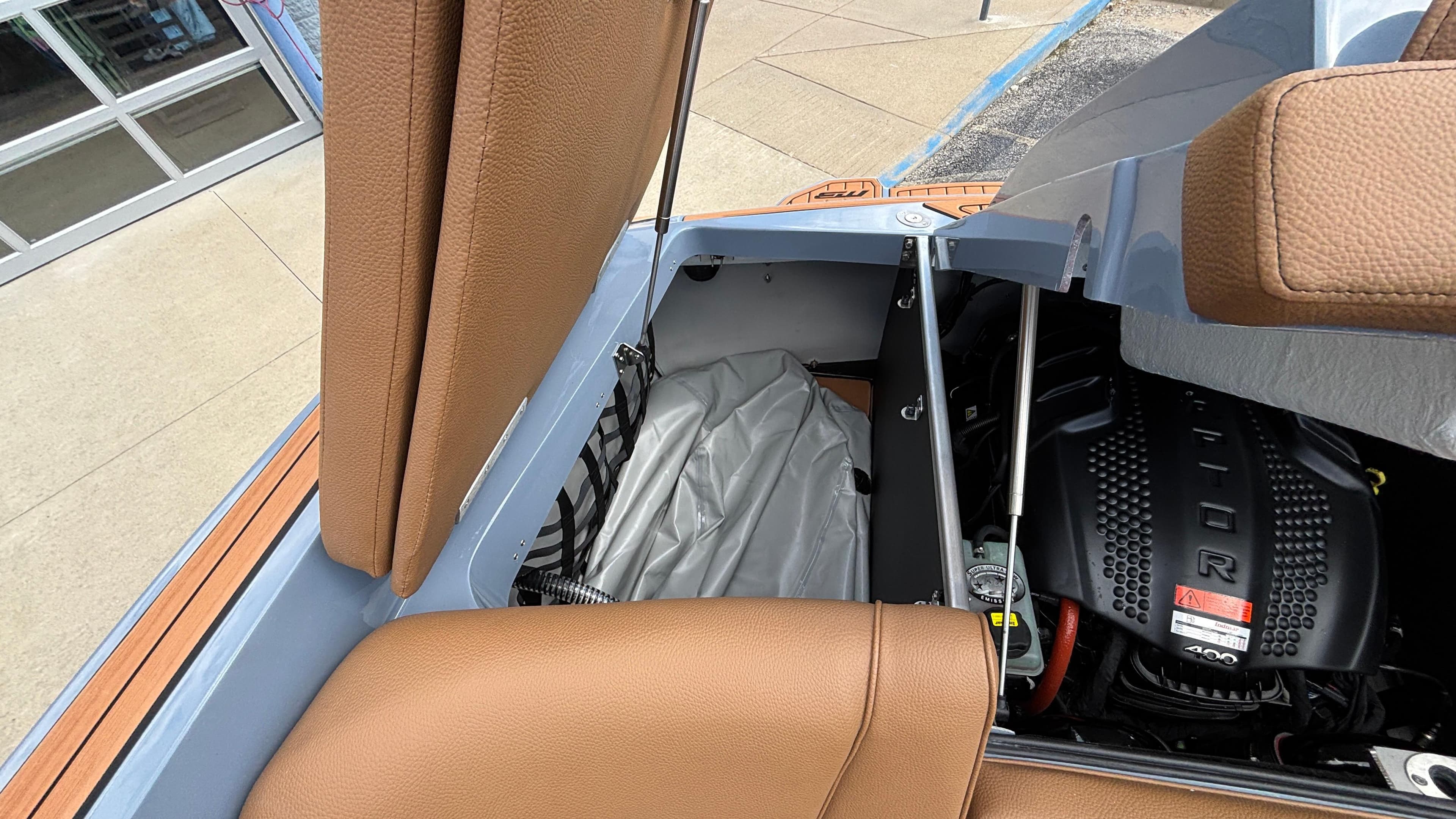 Open engine compartment of 2025 MB B52 23 Alpha with tan leather interior.