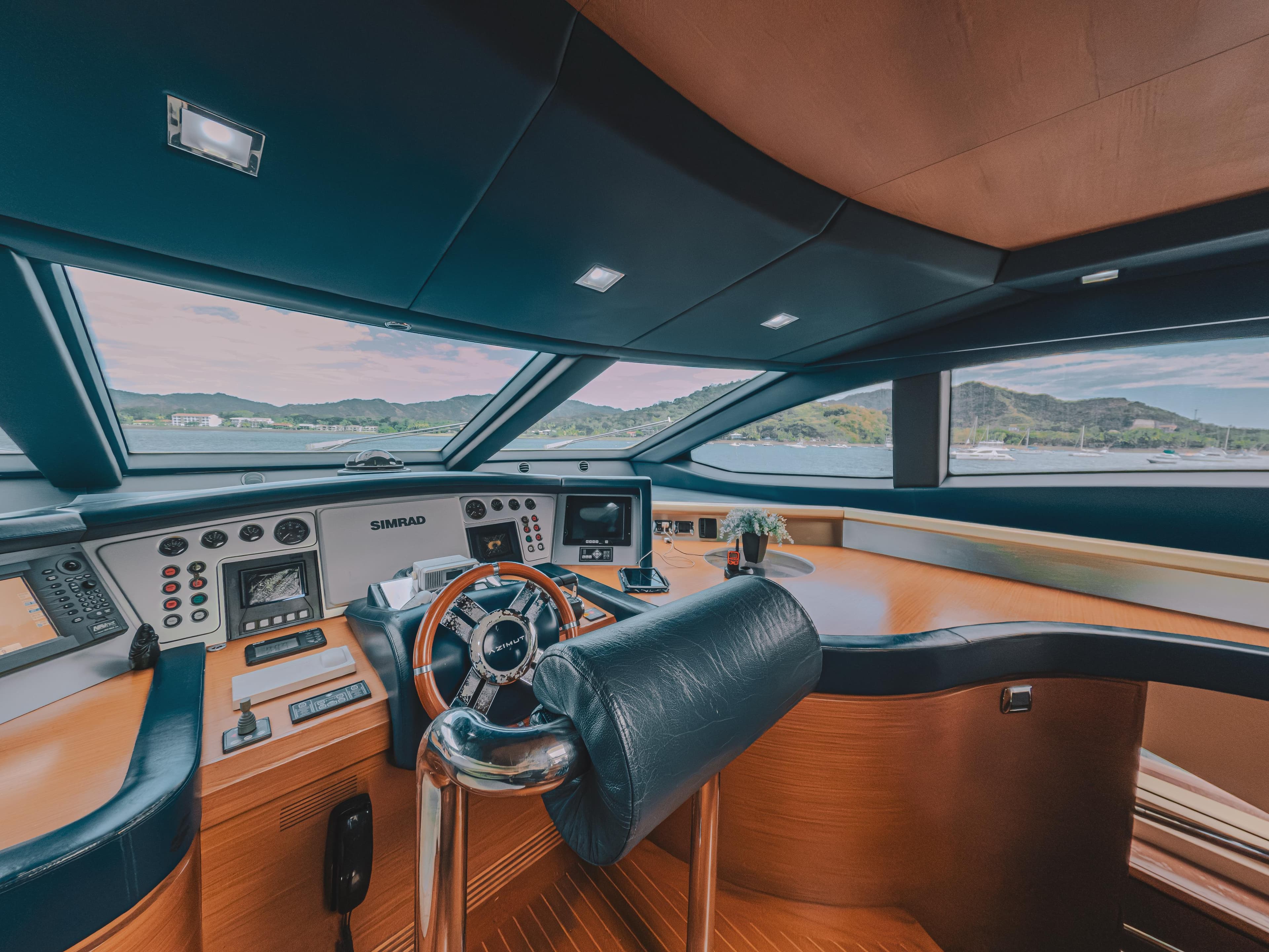Luxurious helm of 2006 Azimut 105 yacht with modern navigation equipment.